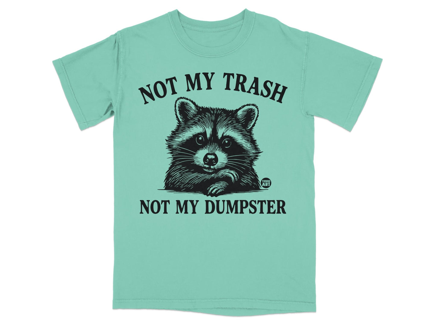 Mint t-shirt with raccoon graphic and text "NOT MY TRASH NOT MY DUMPSTER".