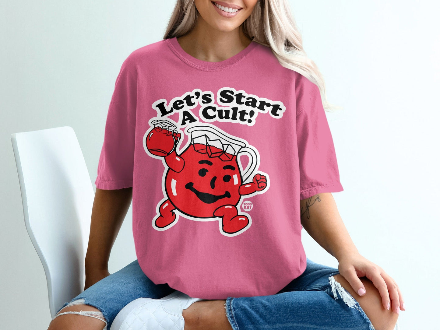 Pink t-shirt featuring Kool-Aid Man saying "Let's Start A Cult!"