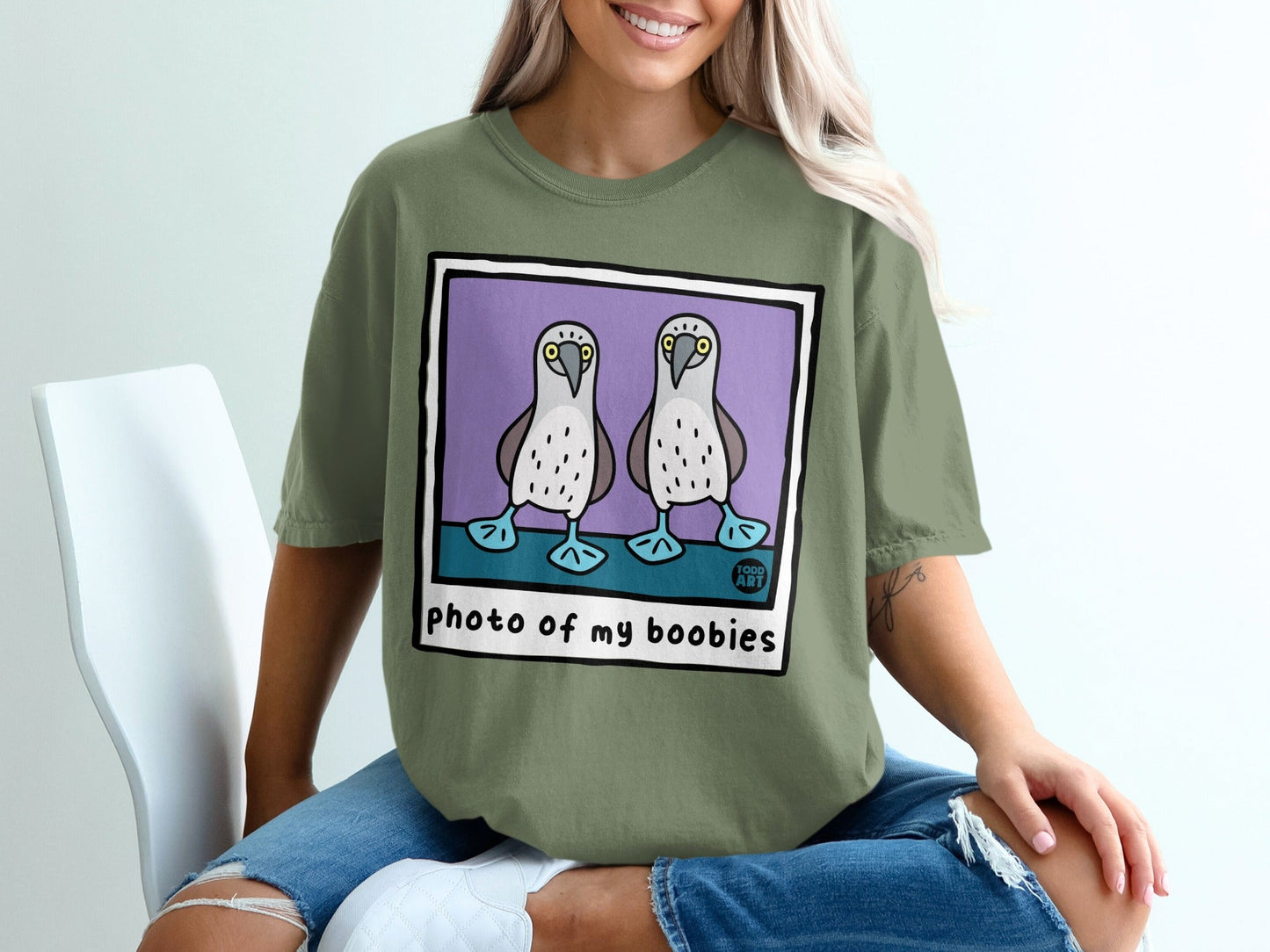 T-shirt featuring two blue-footed boobies in a purple bordered photograph.