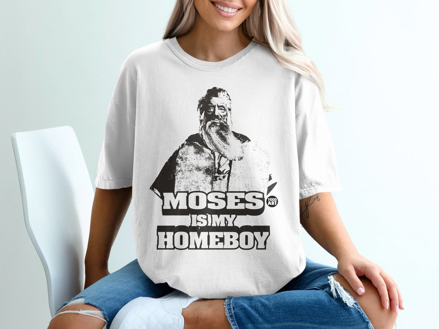 White t-shirt with "MOSES IS MY HOMEBOY" text and portrait of Moses.