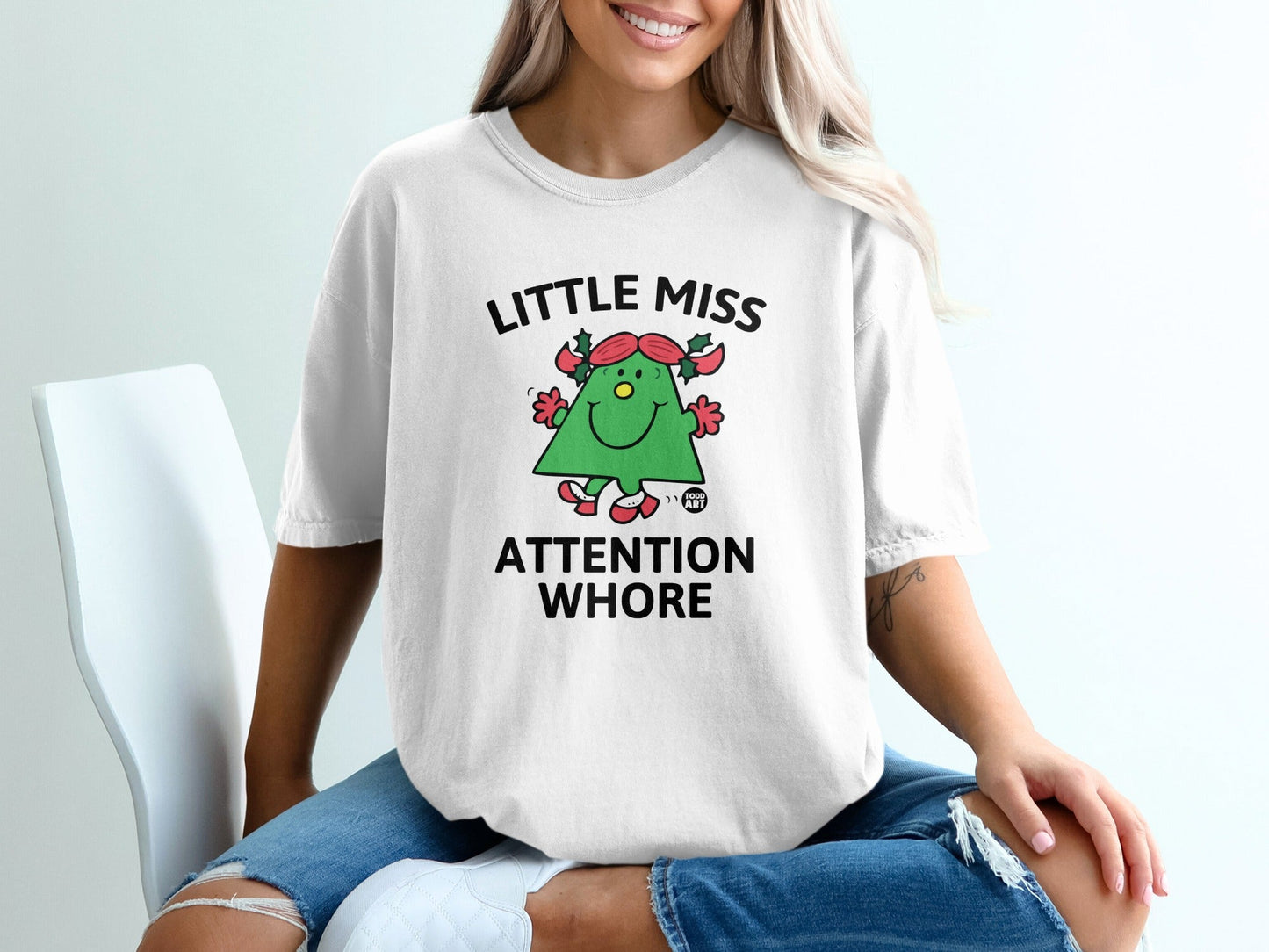 White t-shirt with "Little Miss Attention Whore" text and a cartoon tree.