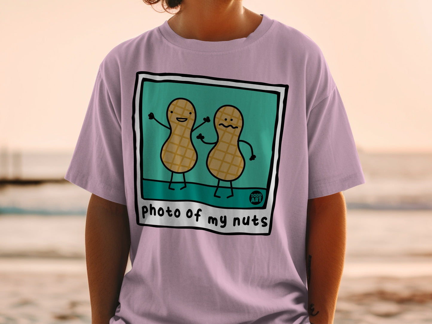 Two cartoon peanuts with smiling faces on a t-shirt.