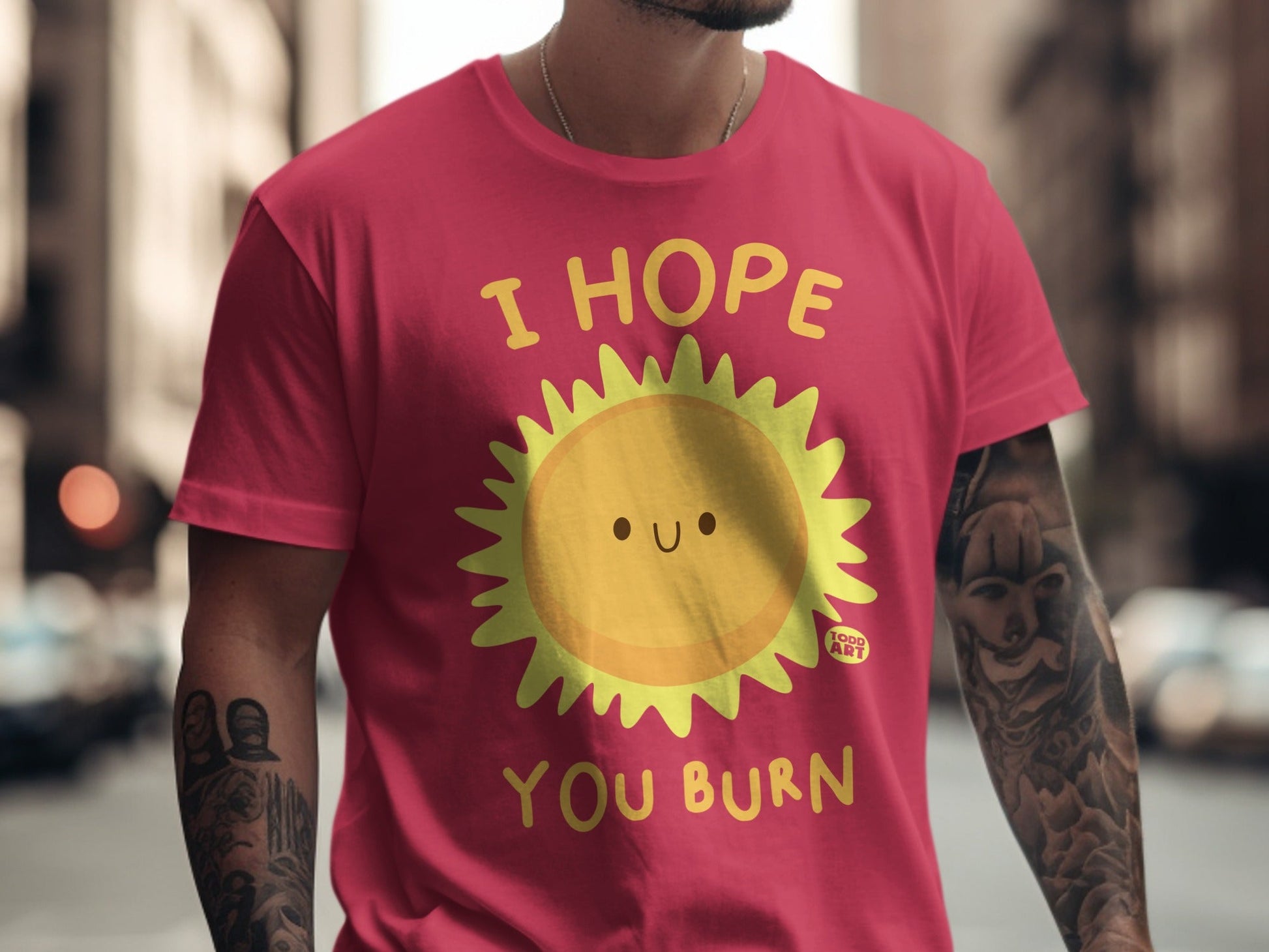 Pink t-shirt with cartoon sun graphic and text "I HOPE YOU BURN."