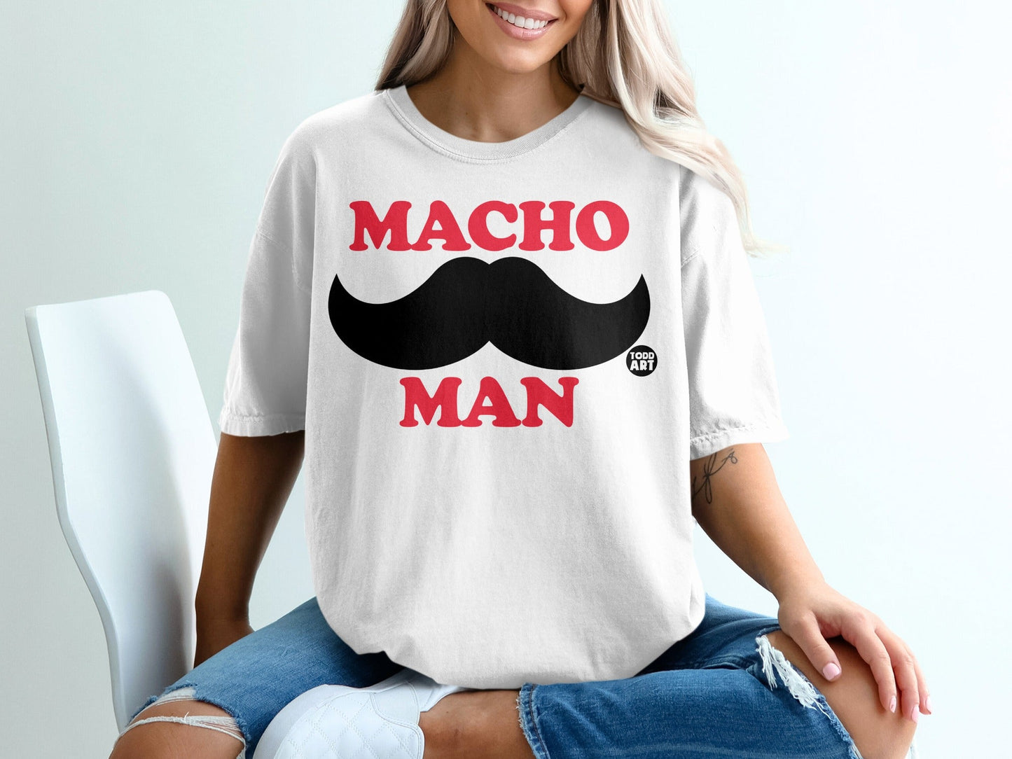 White t-shirt with "MACHO MAN" and mustache graphic.