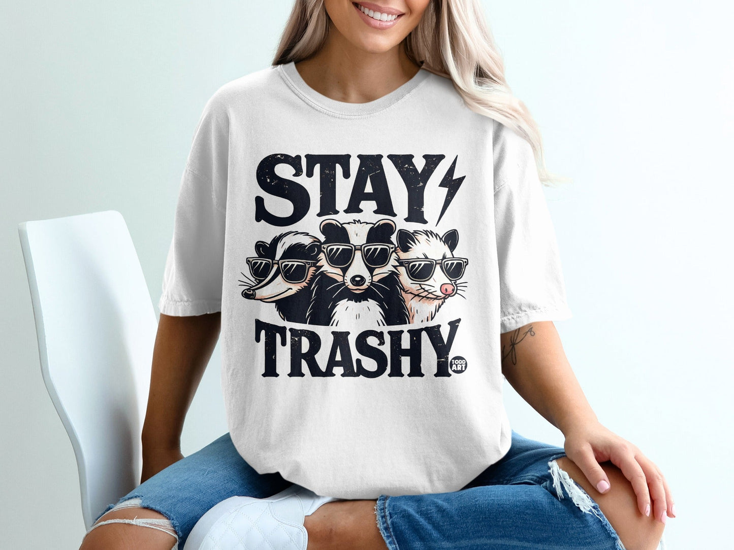 Graphic tee with badgers wearing sunglasses and "Stay Trashy" text.