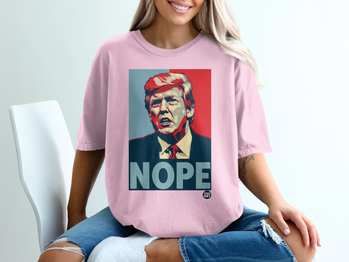Pink t-shirt with portrait of Donald Trump and the word "NOPE".