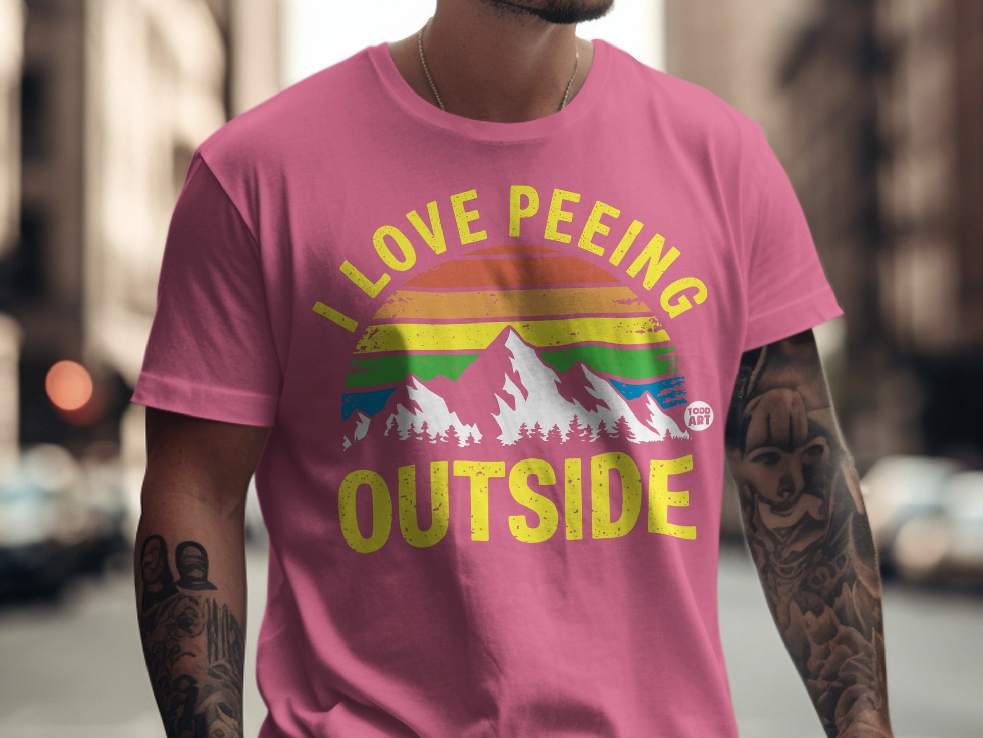 Pink t-shirt with "I LOVE PE‚ÄãEING OUTSIDE" and a mountain range graphic.