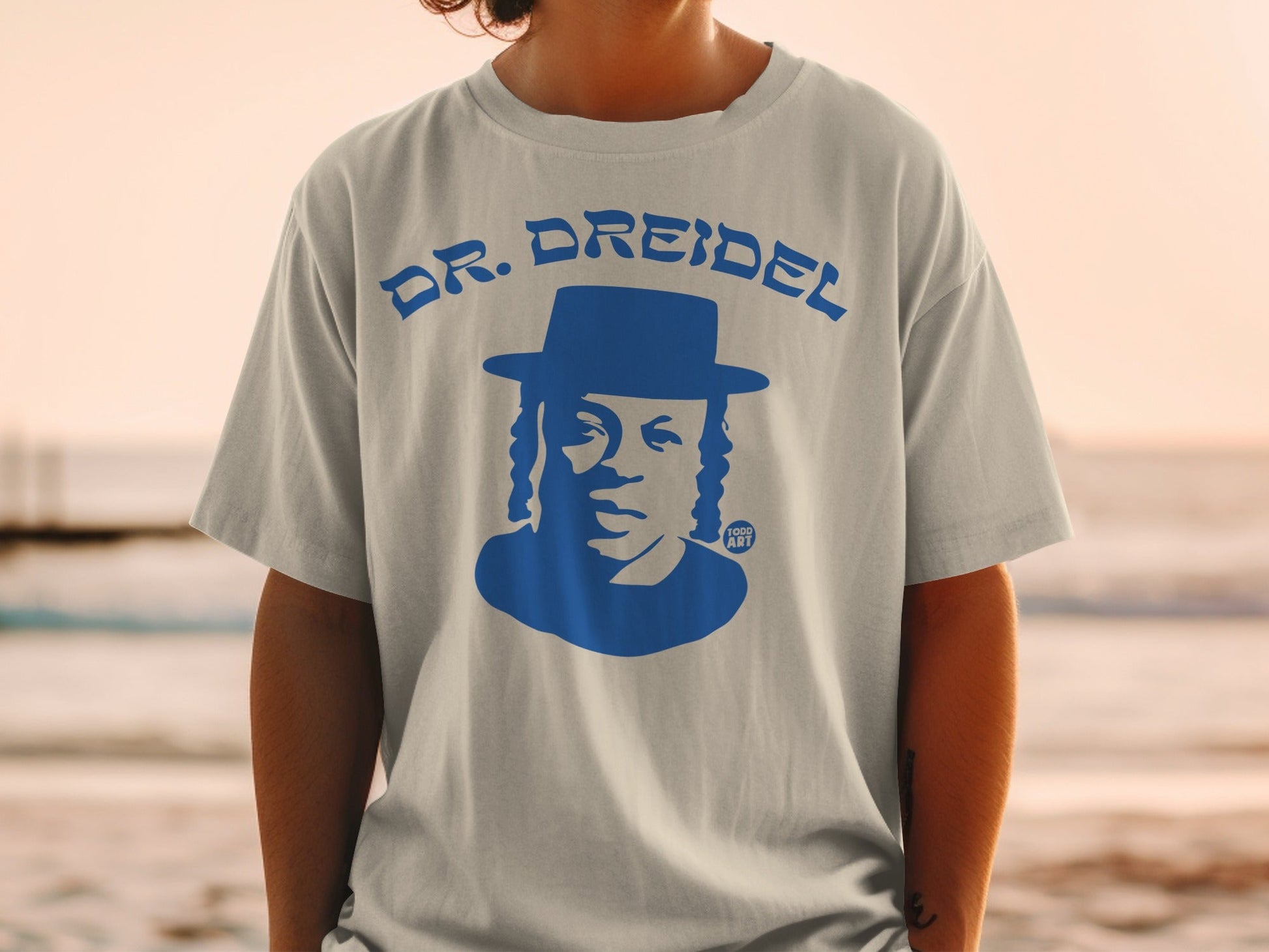 Blue graphic of a man in a hat with "DR. DREIDEL" text.
