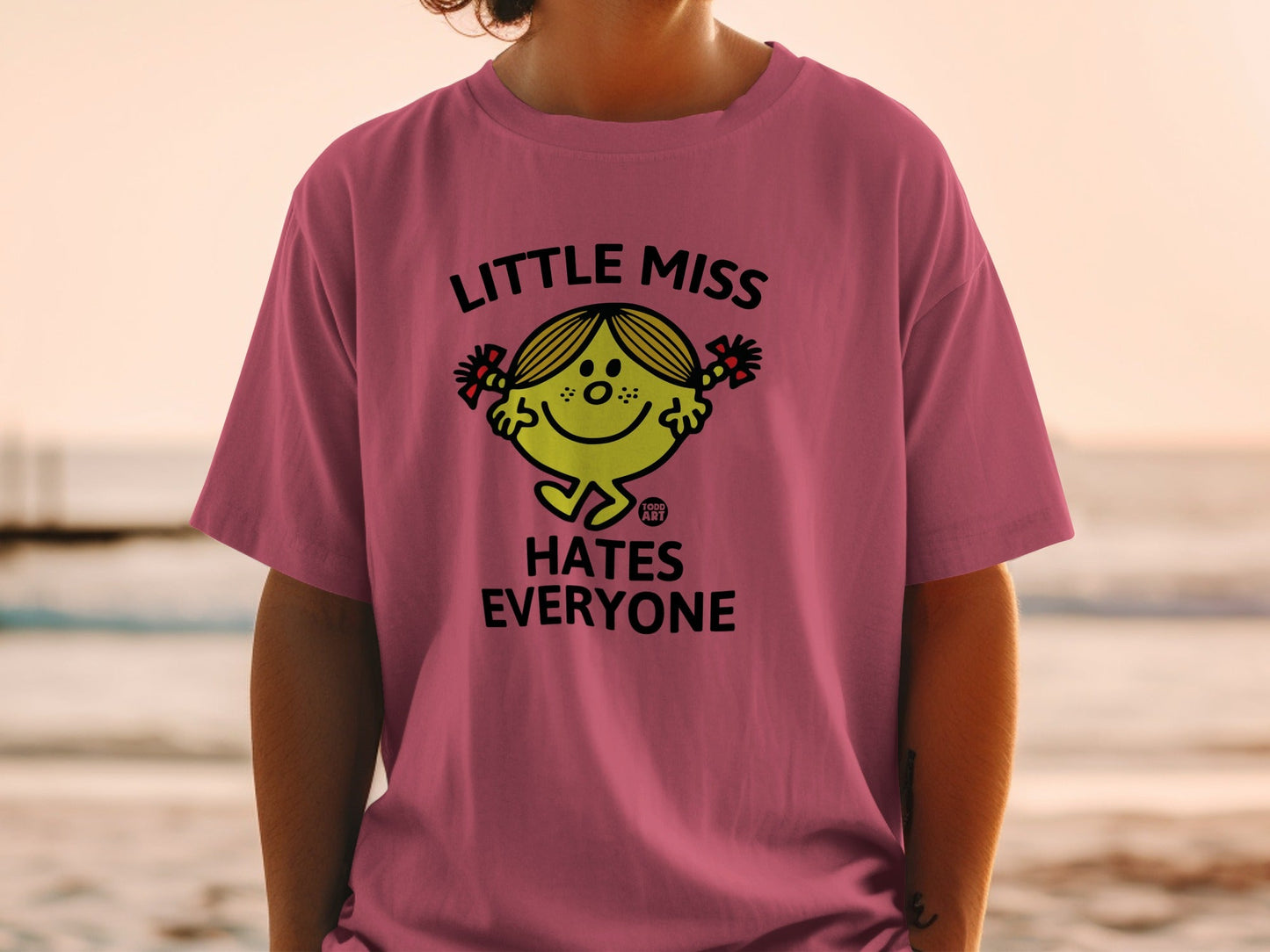 Pink t-shirt with "Little Miss Hates Everyone" graphic on a person.