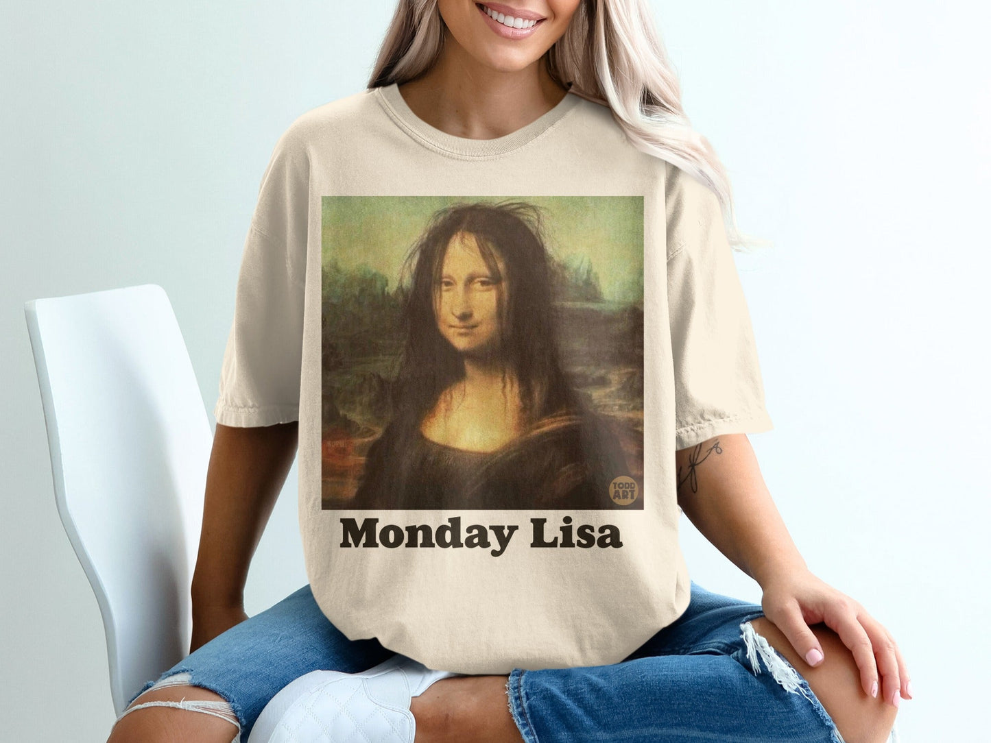 T-shirt with "Monday Lisa" text featuring a messy-haired Mona Lisa painting.
