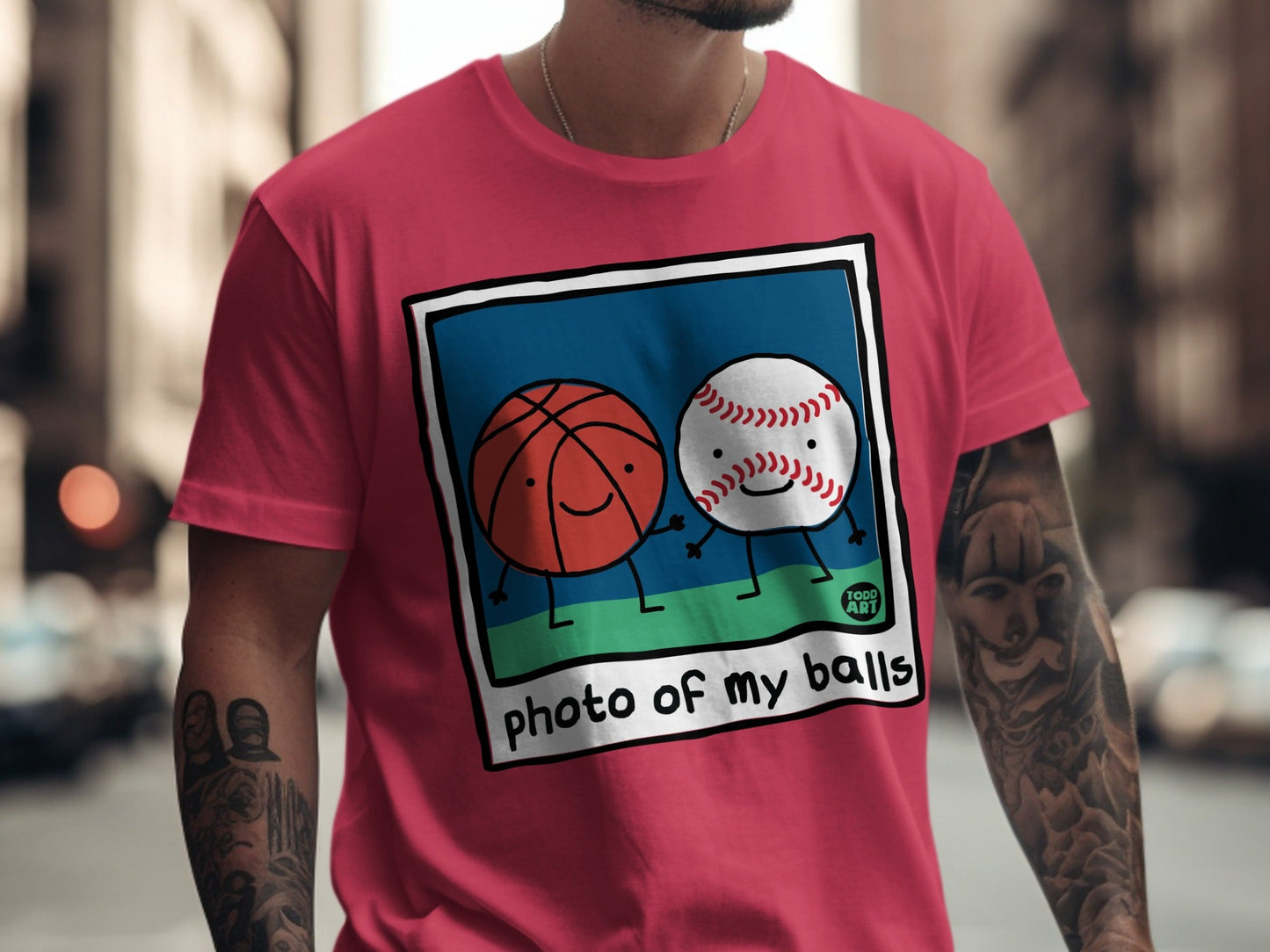 Pink t-shirt with cartoon basketball and baseball smiling, text "photo of my balls".