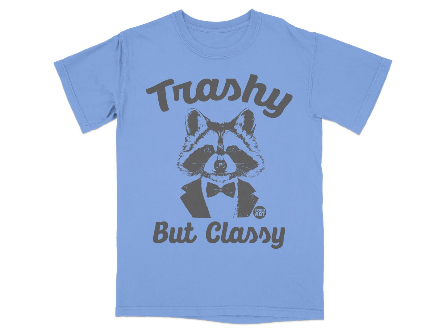 Light blue t-shirt with a raccoon in a tuxedo and the text "Trashy But Classy".