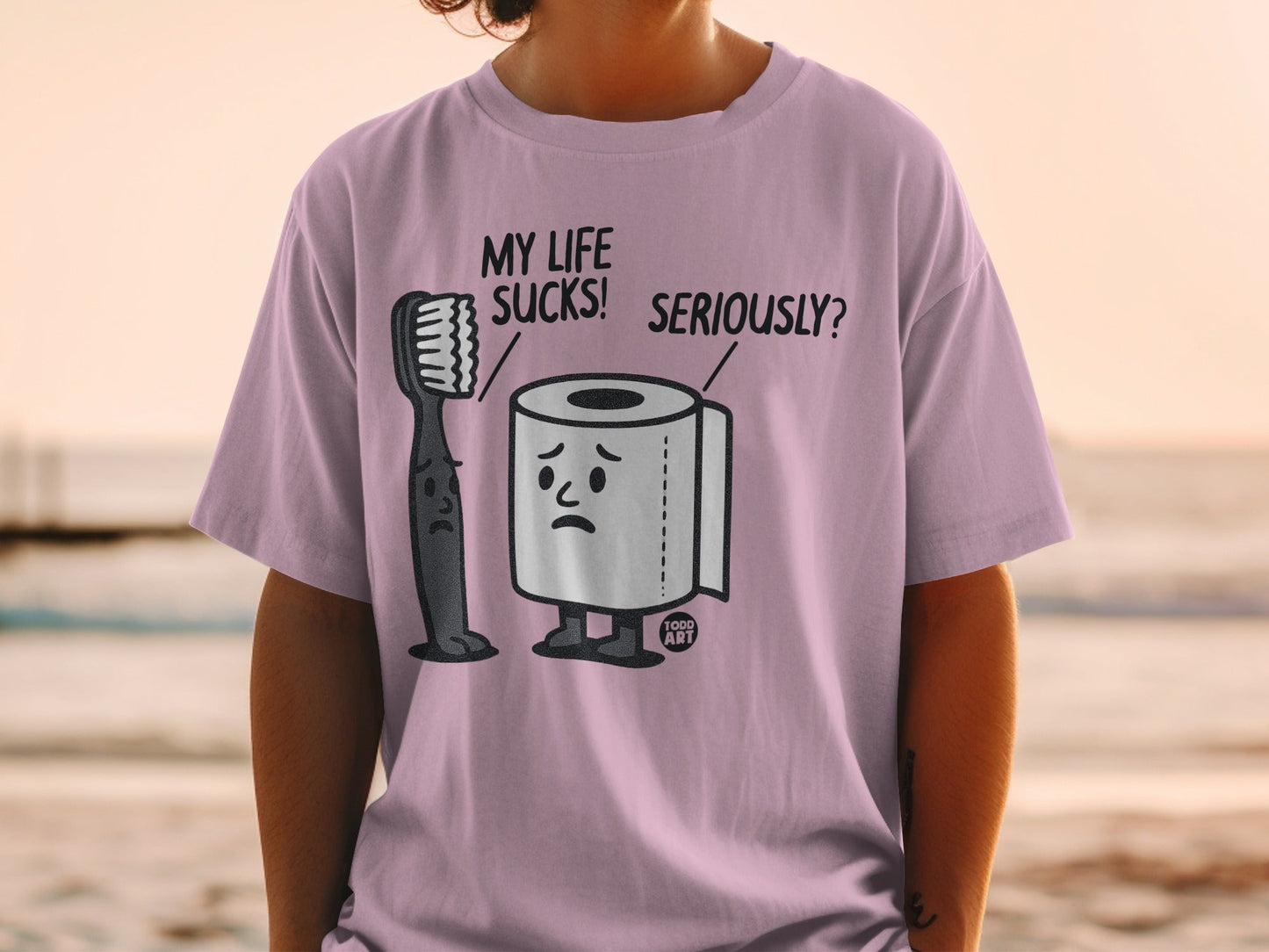 T-shirt with graphic of sad toothbrush and toilet paper saying "My life sucks! Seriously?".