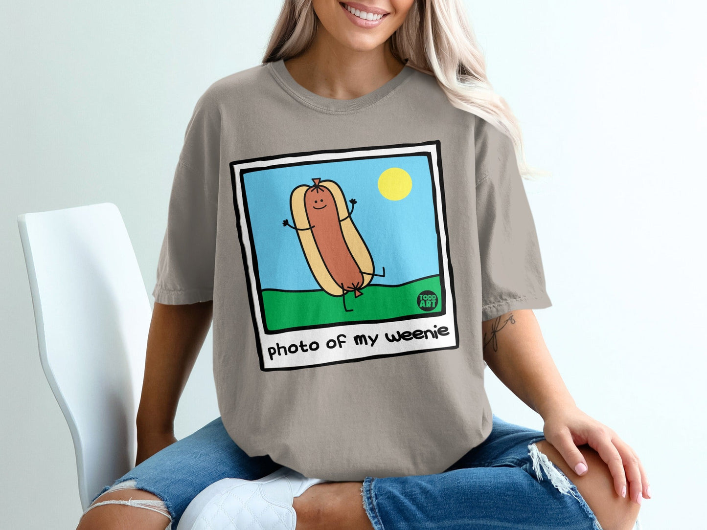 Cartoon hot dog with arms and legs dancing, "photo of my weenie" text.