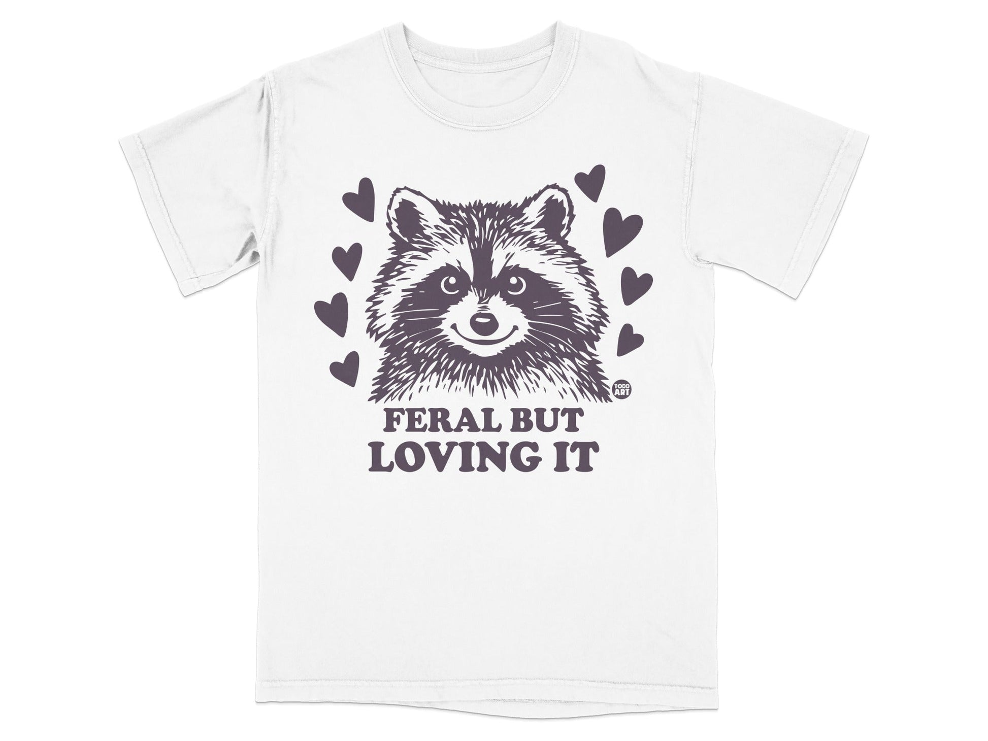 White t-shirt with raccoon graphic and "Feral but loving it" text.