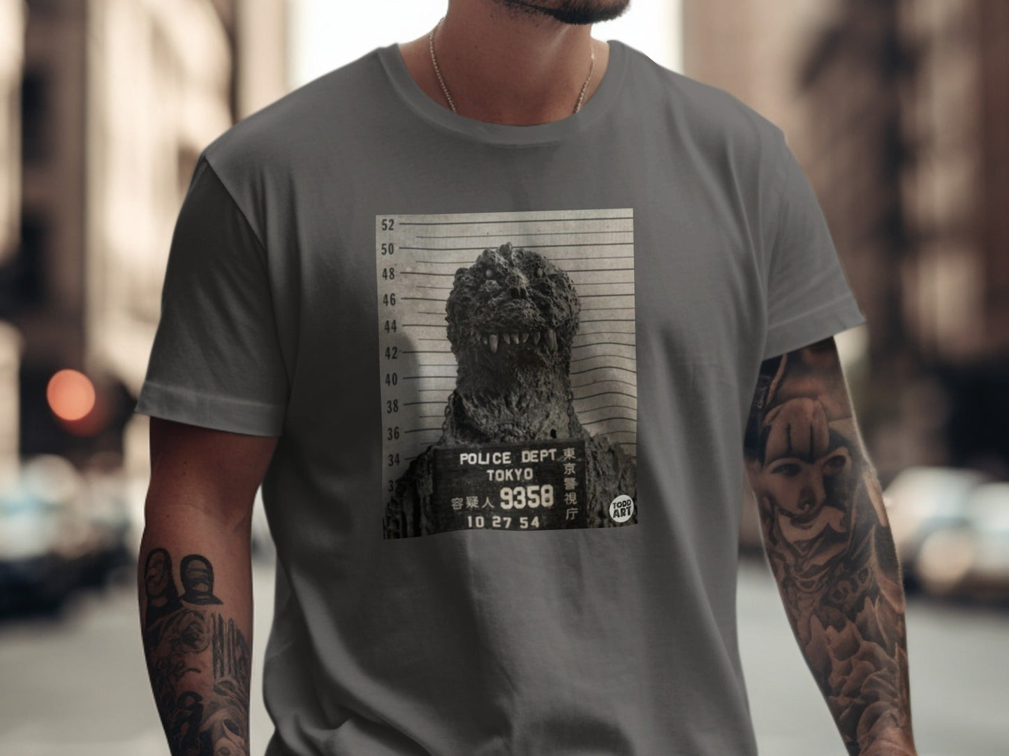 Grey t-shirt featuring a mugshot of Godzilla with Japanese text.