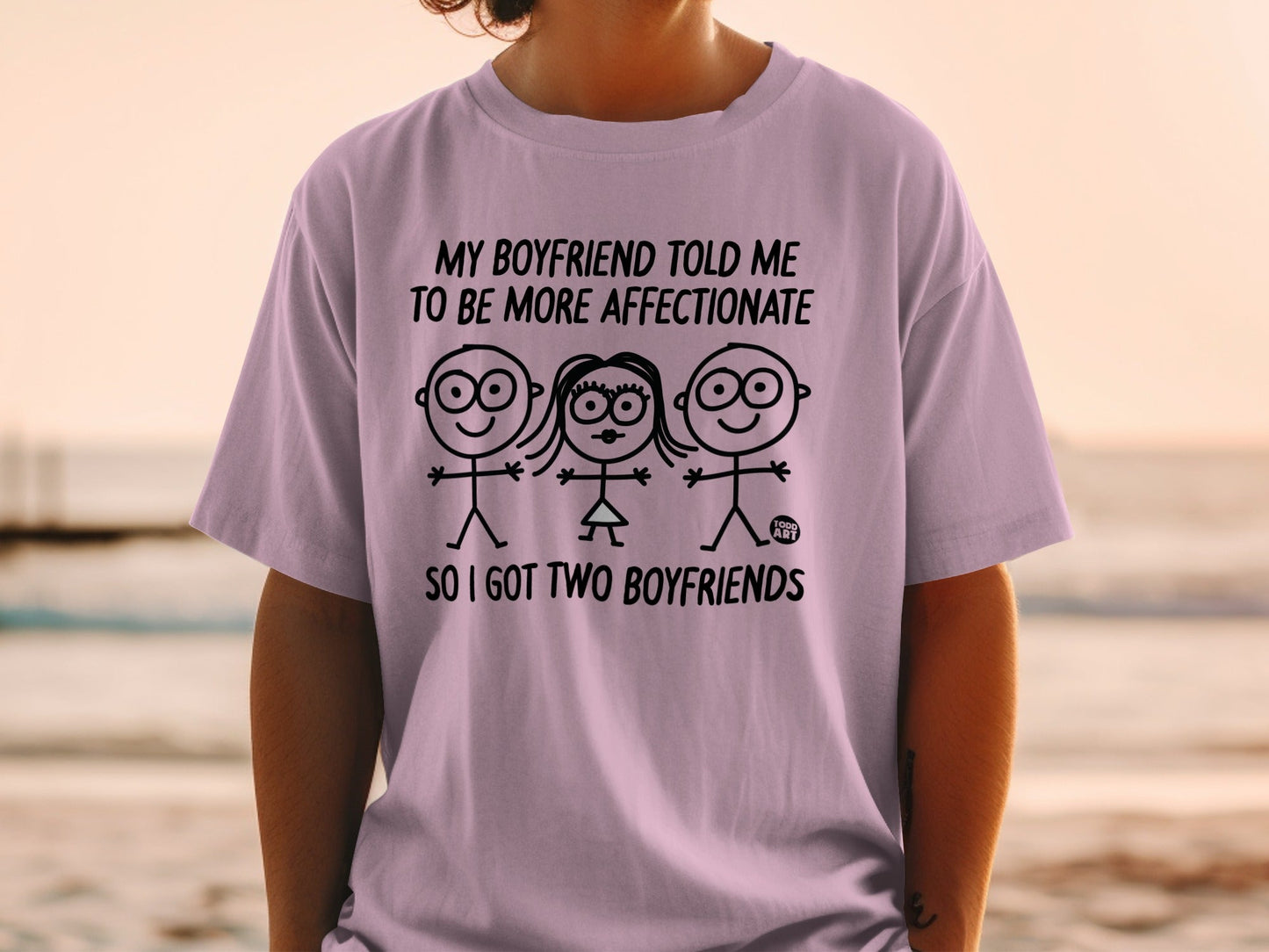 T-shirt with cartoon couple and text "My boyfriend told me to be more affectionate so I got two boyfriends".