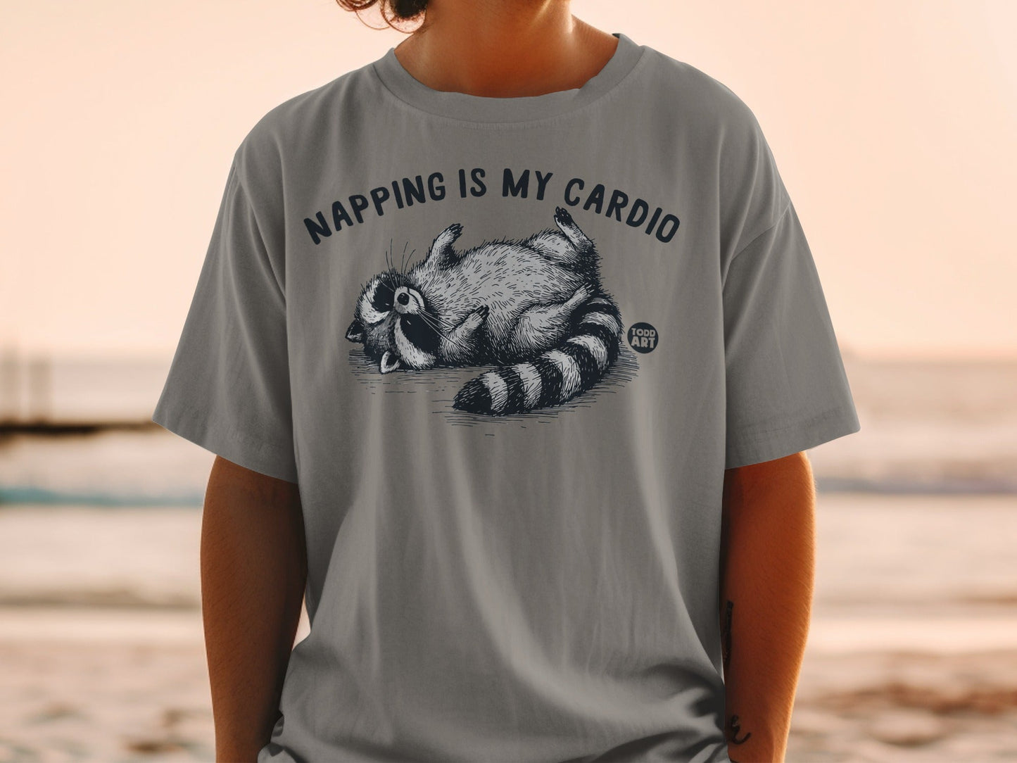 Gray t-shirt with raccoon graphic and "NAPPING IS MY CARDIO" text.