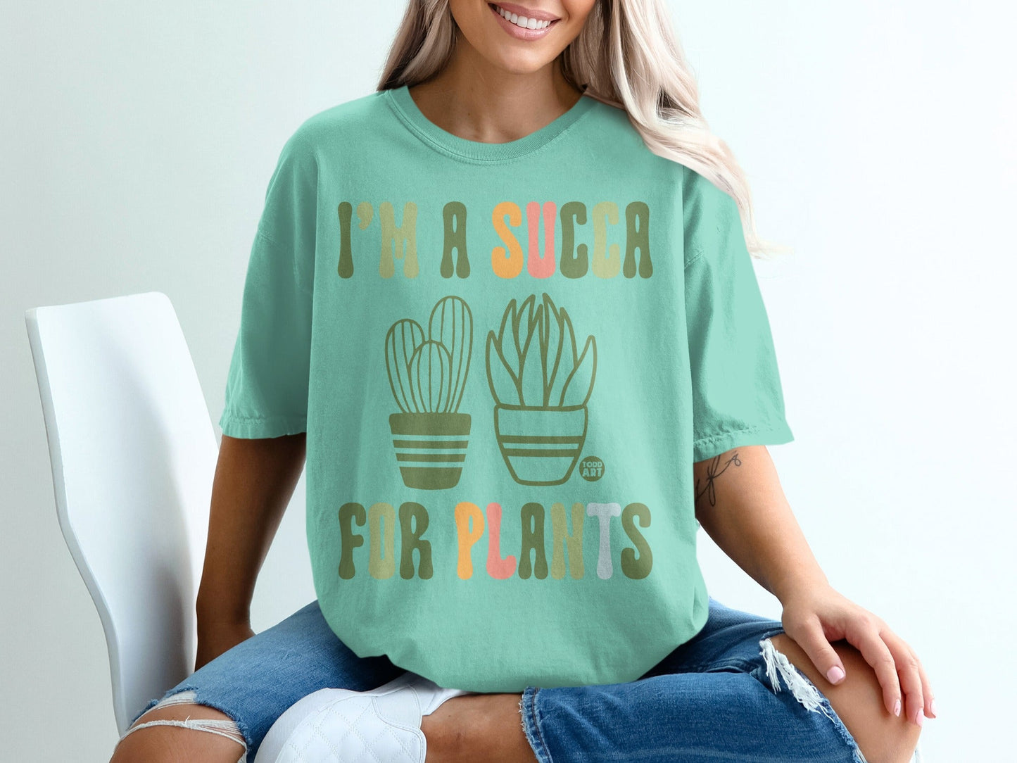 Mint t-shirt with cacti and succulents and text "I'm a sucker for plants".