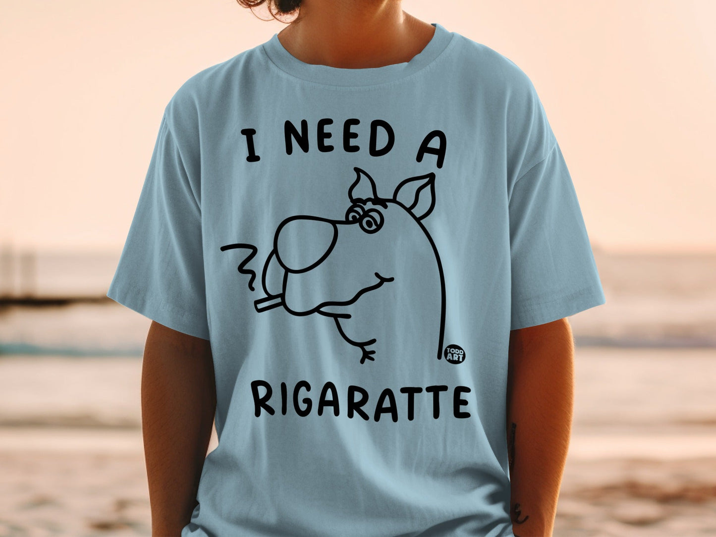 Scooby-Doo on a light blue t-shirt with "I NEED A RIGARETTE" text.