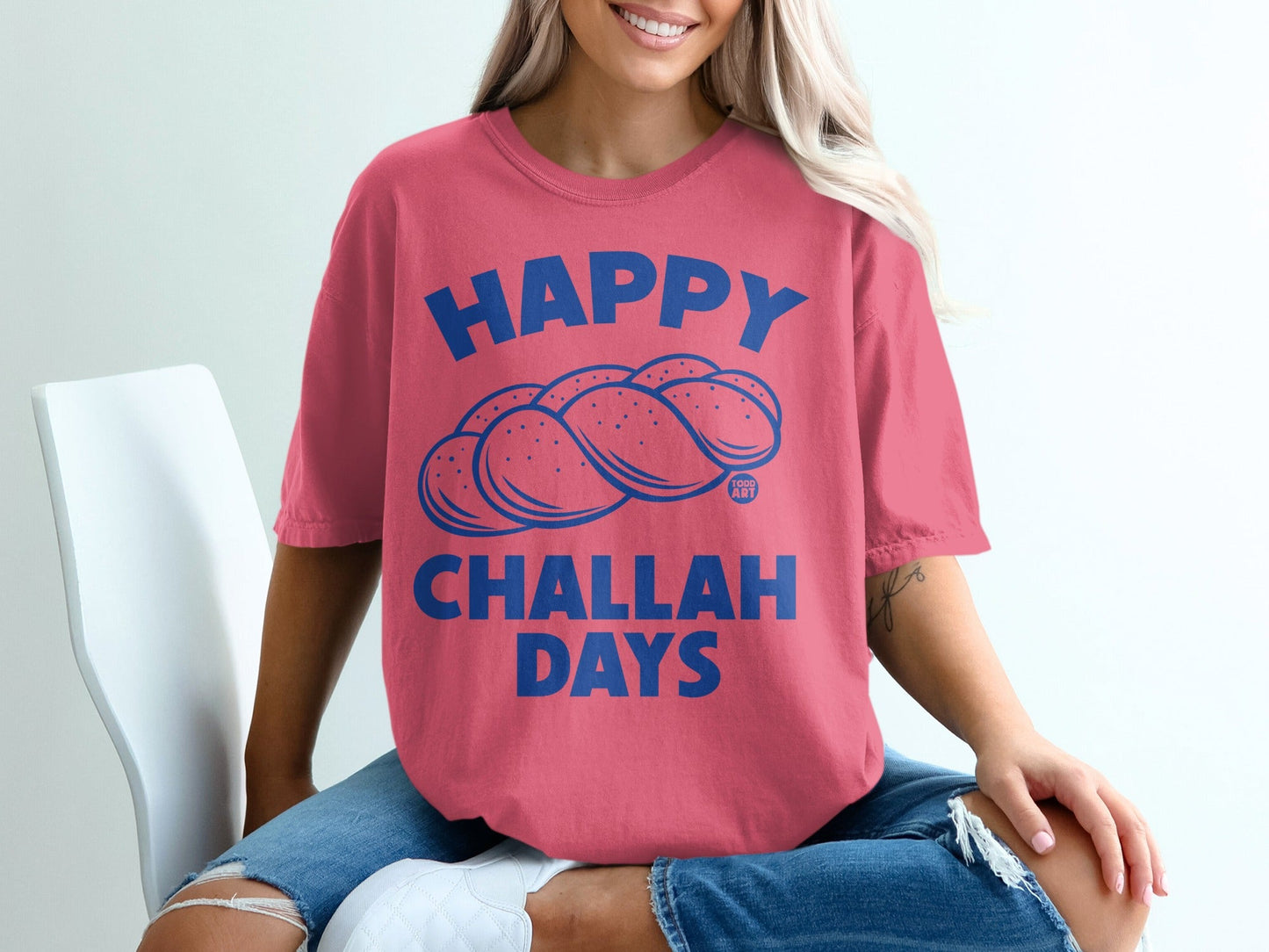 Pink t-shirt with blue text "HAPPY CHALLAH DAYS" and challah bread graphic.