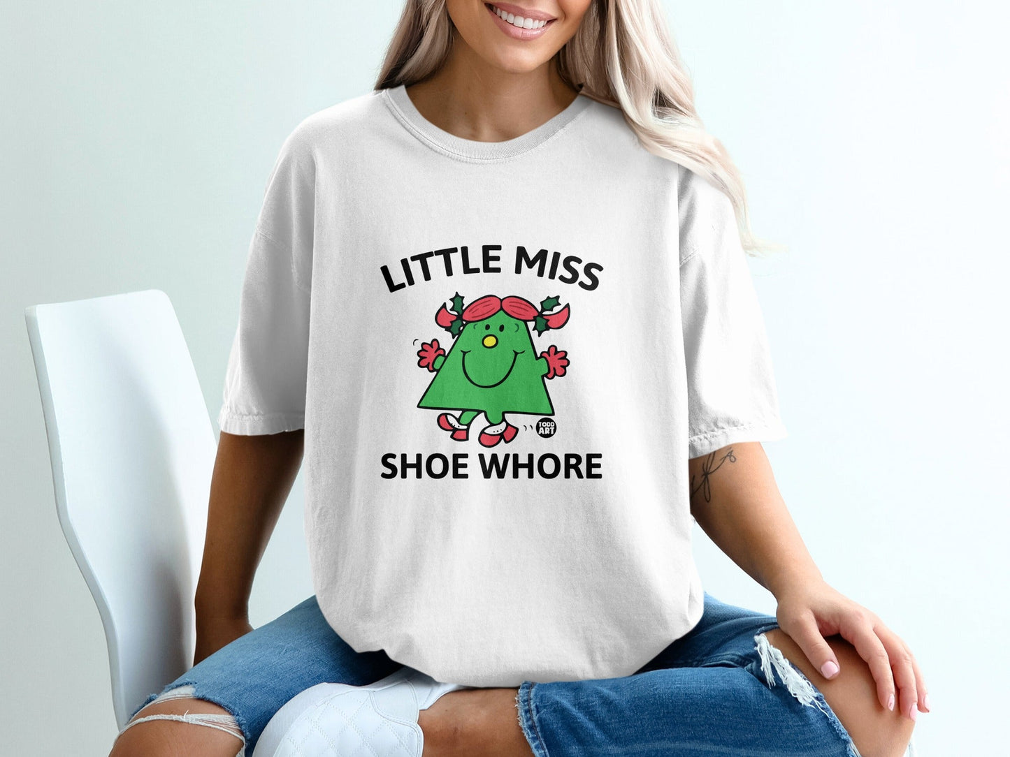 White t-shirt with cartoon Christmas tree saying "Little Miss Shoe Whore".