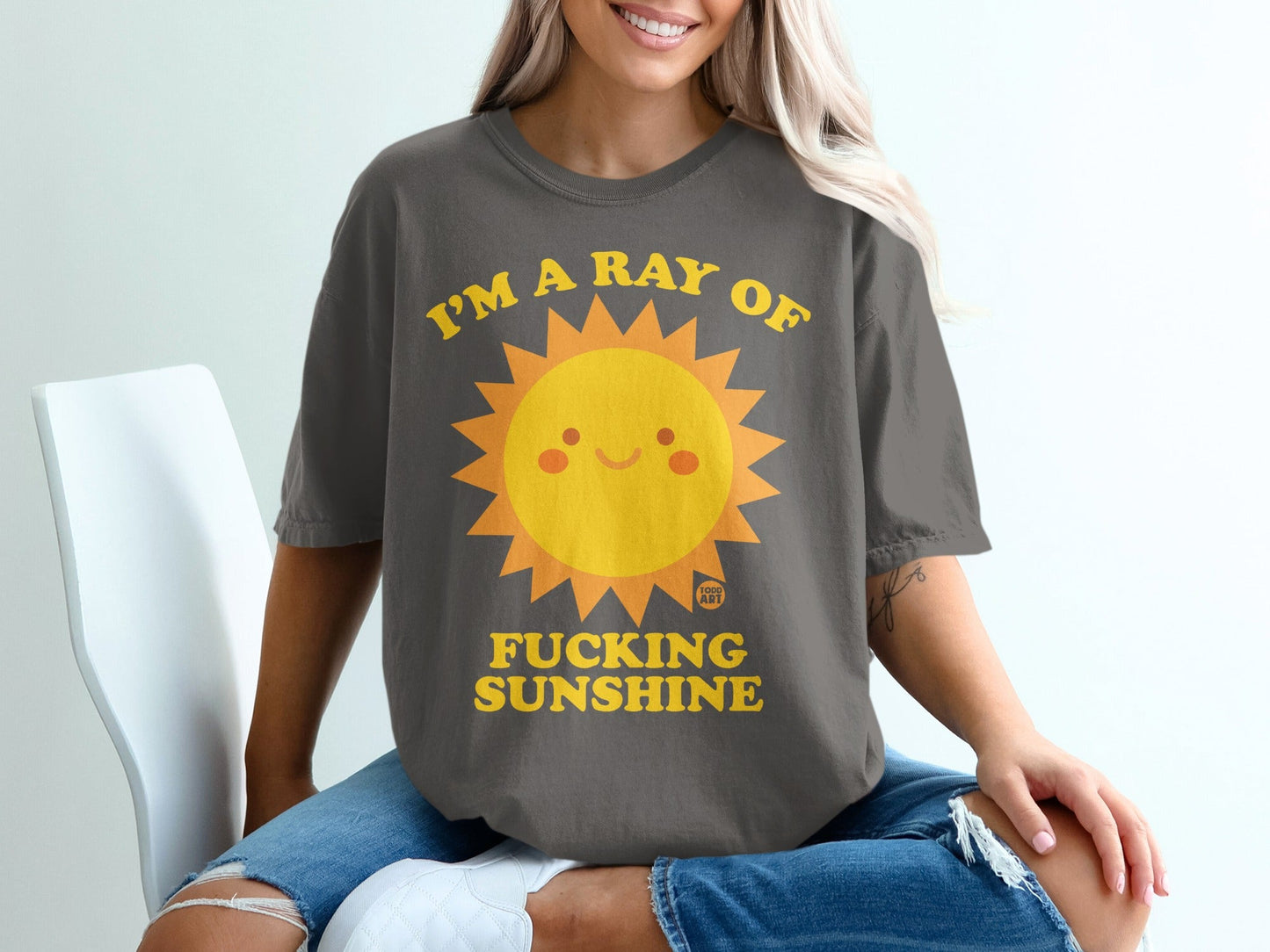 T-shirt with a cartoon sun graphic and text "I'M A RAY OF FUCKING SUNSHINE".