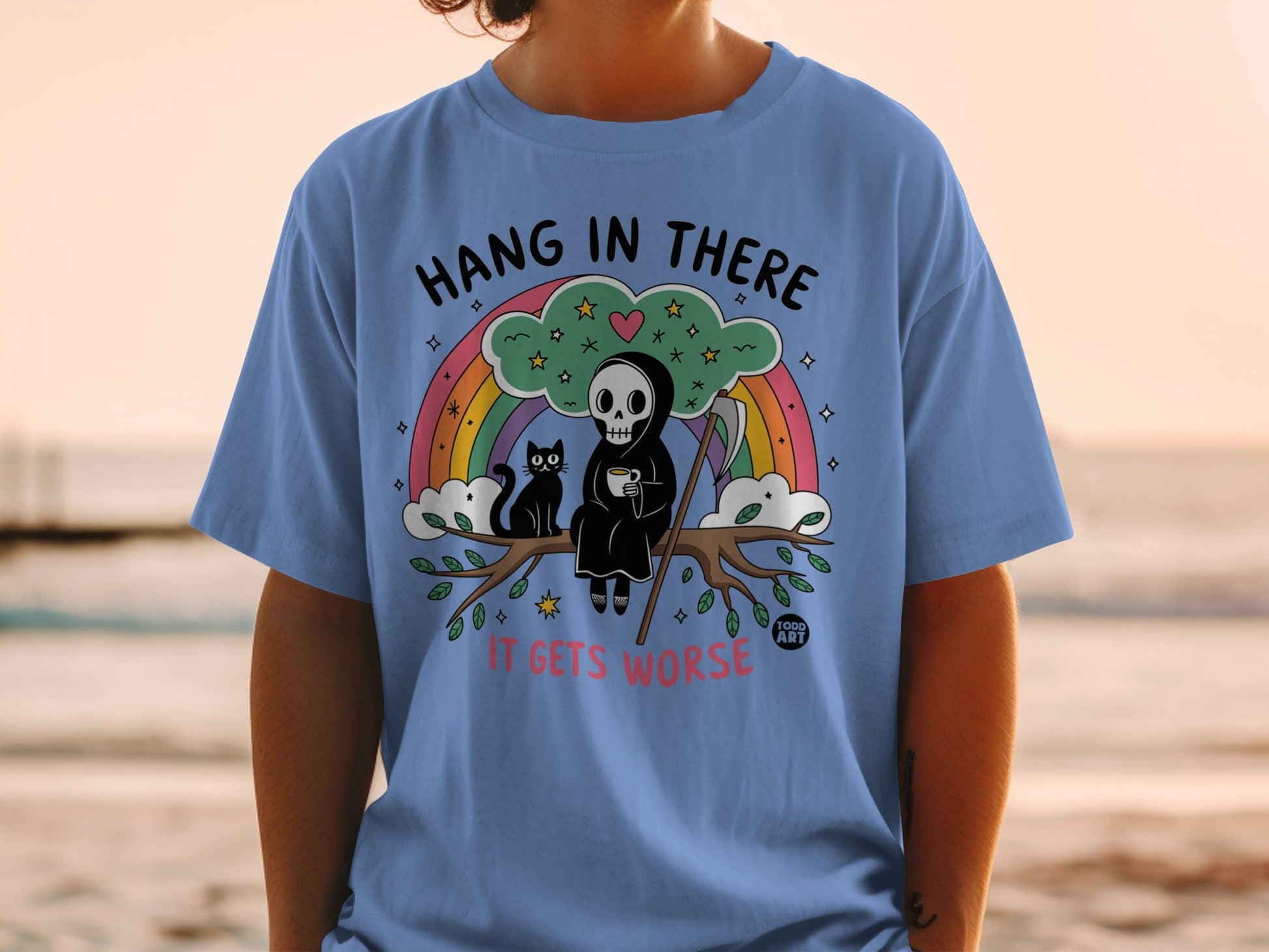 Grim reaper with black cat and rainbow, "Hang in there it gets worse" text.