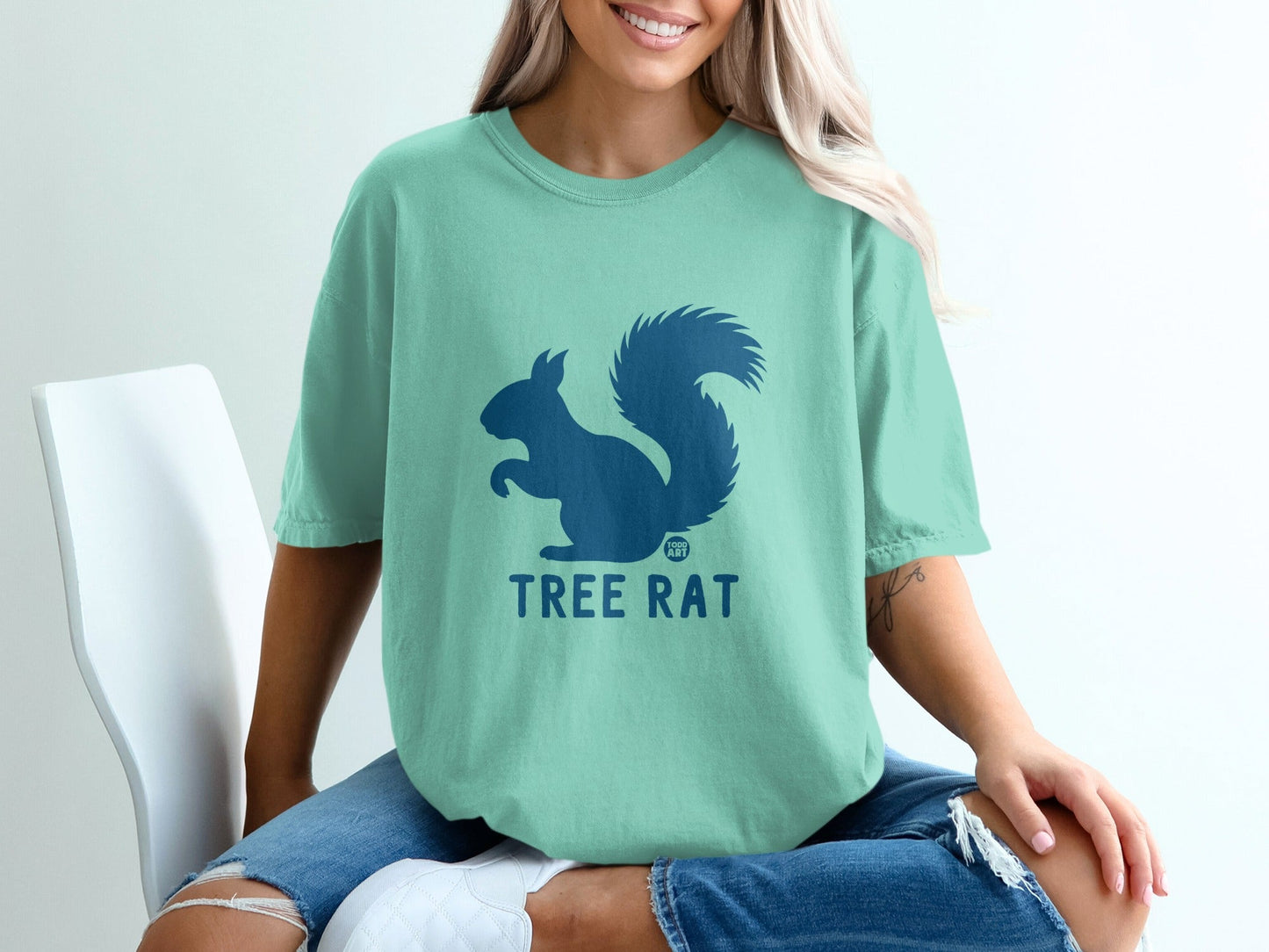 Teal t-shirt with a dark blue squirrel logo and "TREE RAT" text.