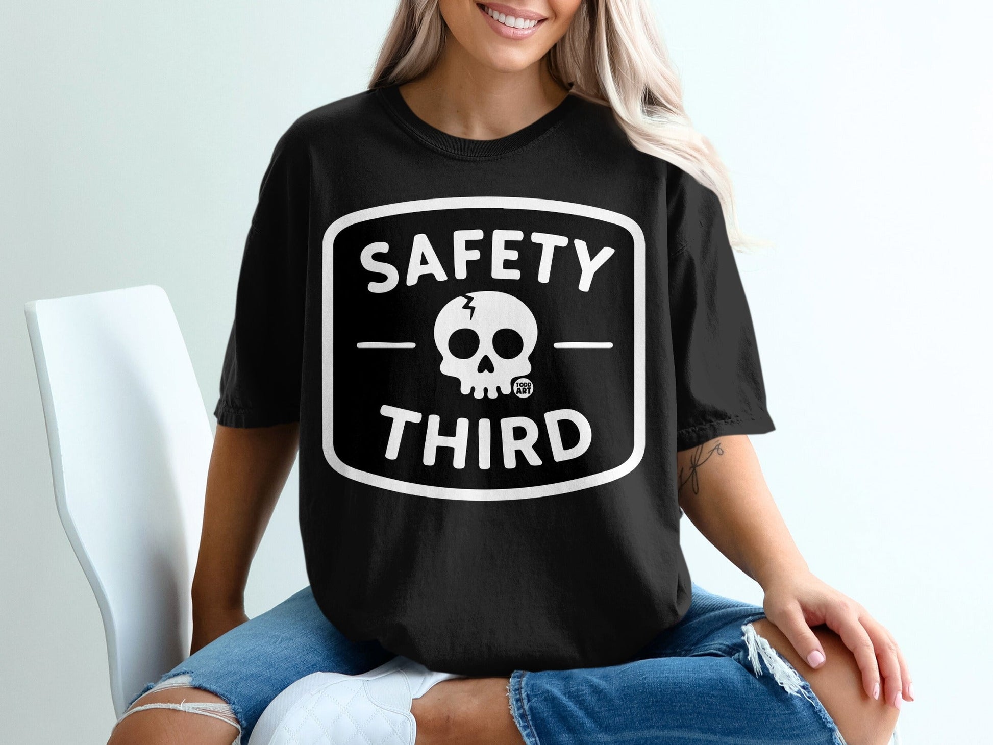 Black t-shirt with white "SAFETY THIRD" text and skull graphic.