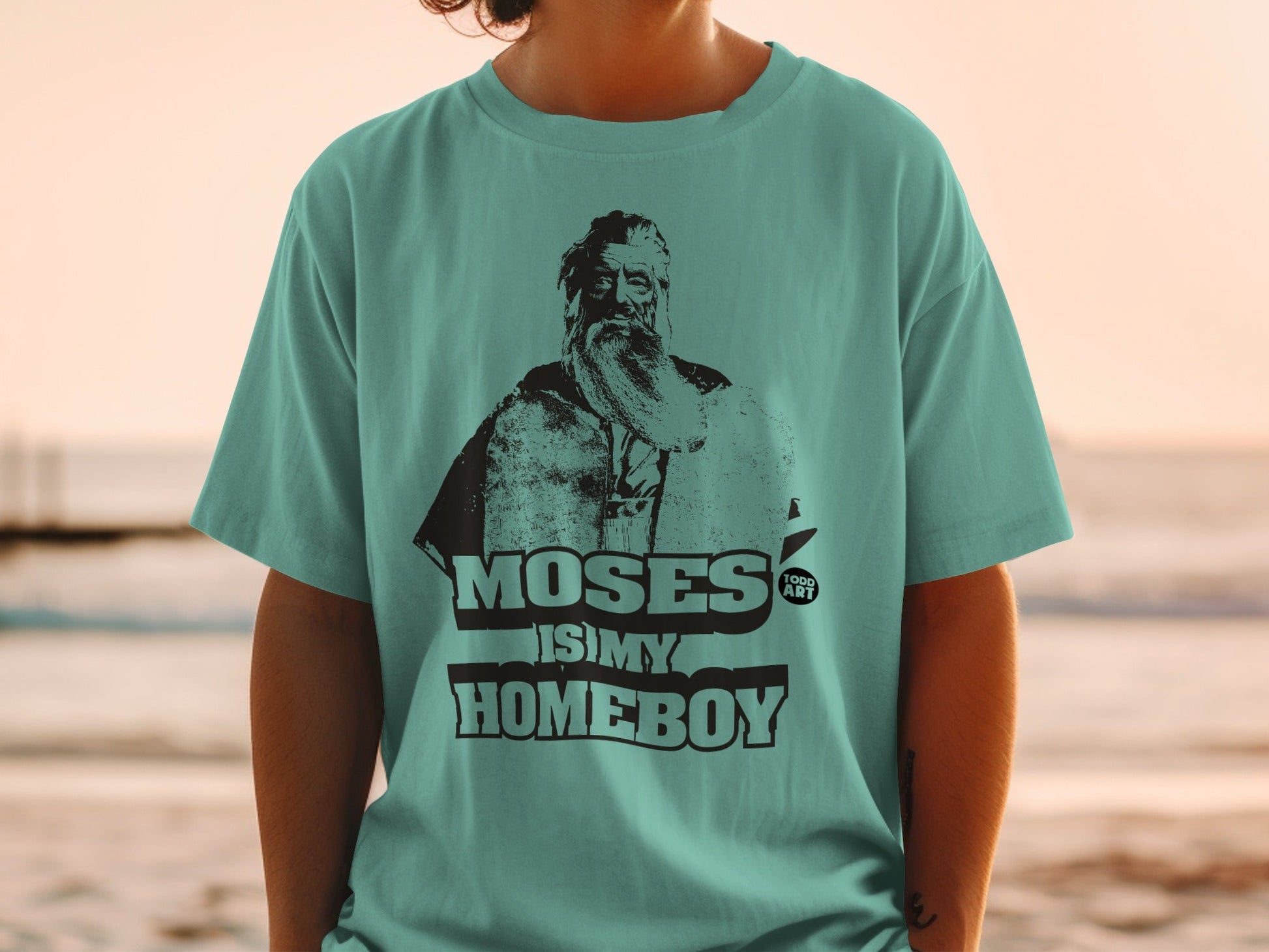 T-shirt with "MOSES IS MY HOMEBOY" and a portrait of Moses.