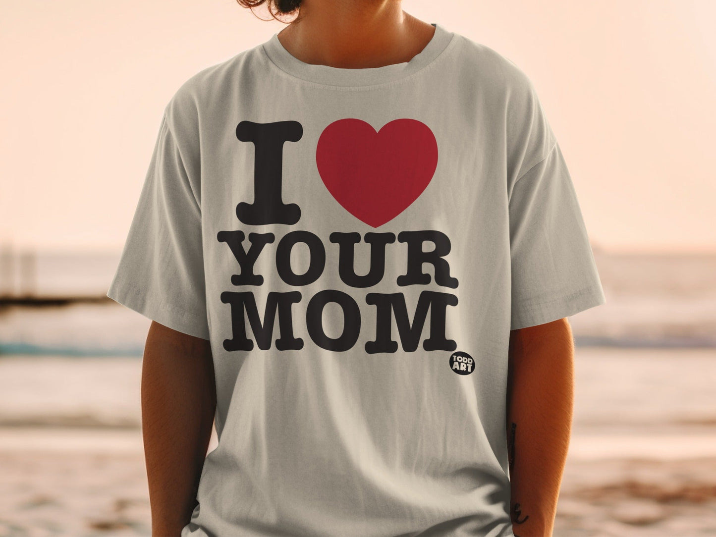 Grey t-shirt with "I ‚ù§Ô∏è YOUR MOM" graphic and small "GOOD ART" logo.