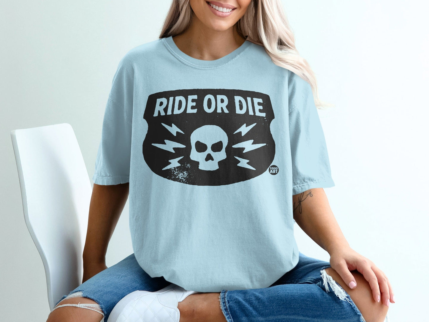 Light blue t-shirt with black "Ride or Die" lightning bolt skull graphic.