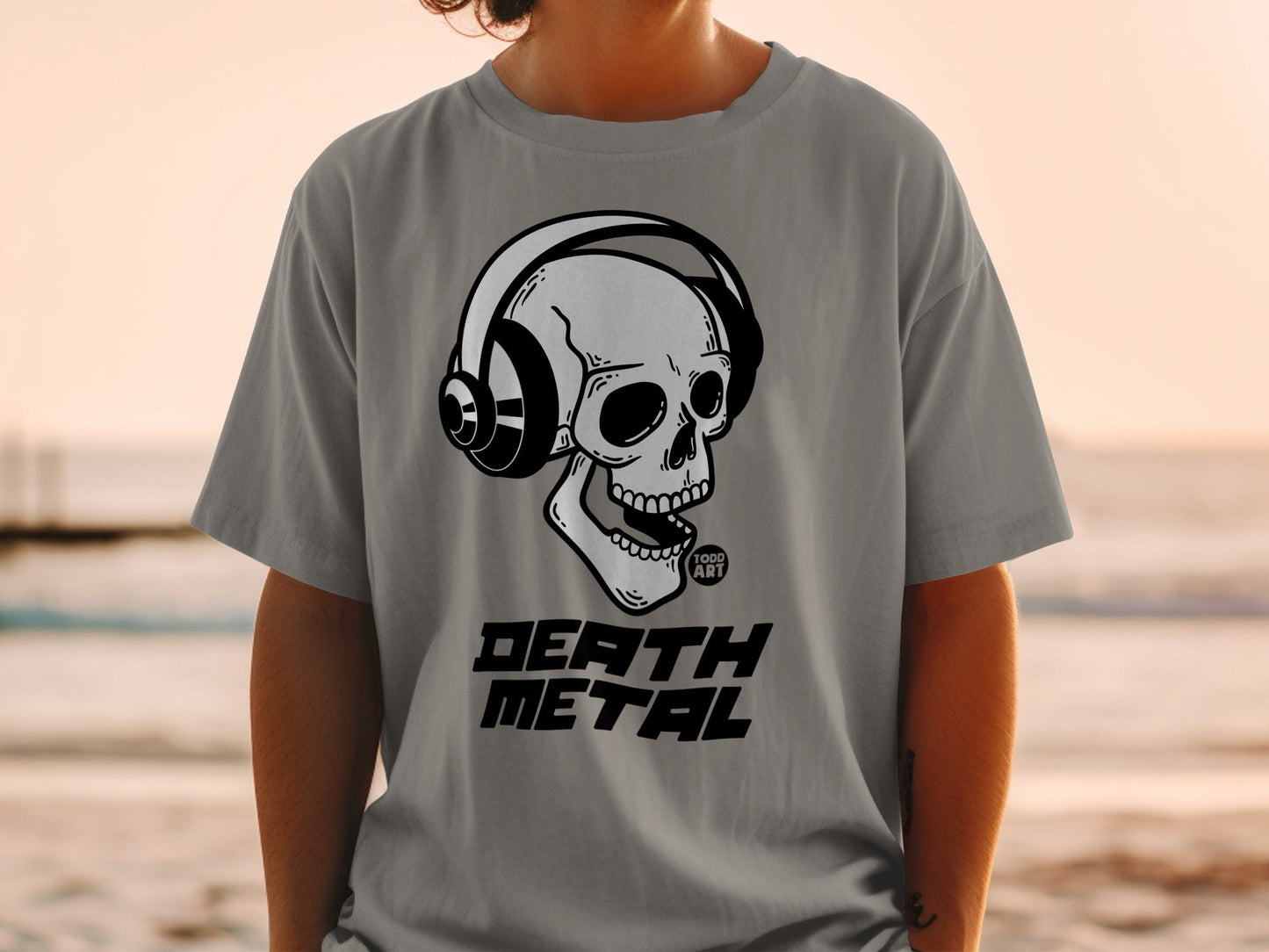 Grey t-shirt with black graphic of a skull wearing headphones and the words "DEATH METAL".