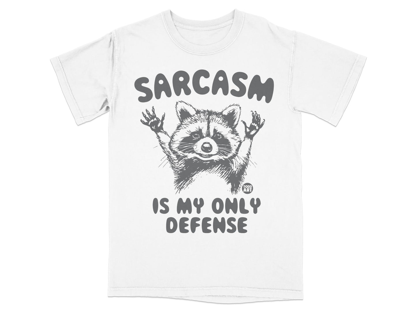 T-shirt with raccoon graphic and "Sarcasm Is My Only Defense" text.