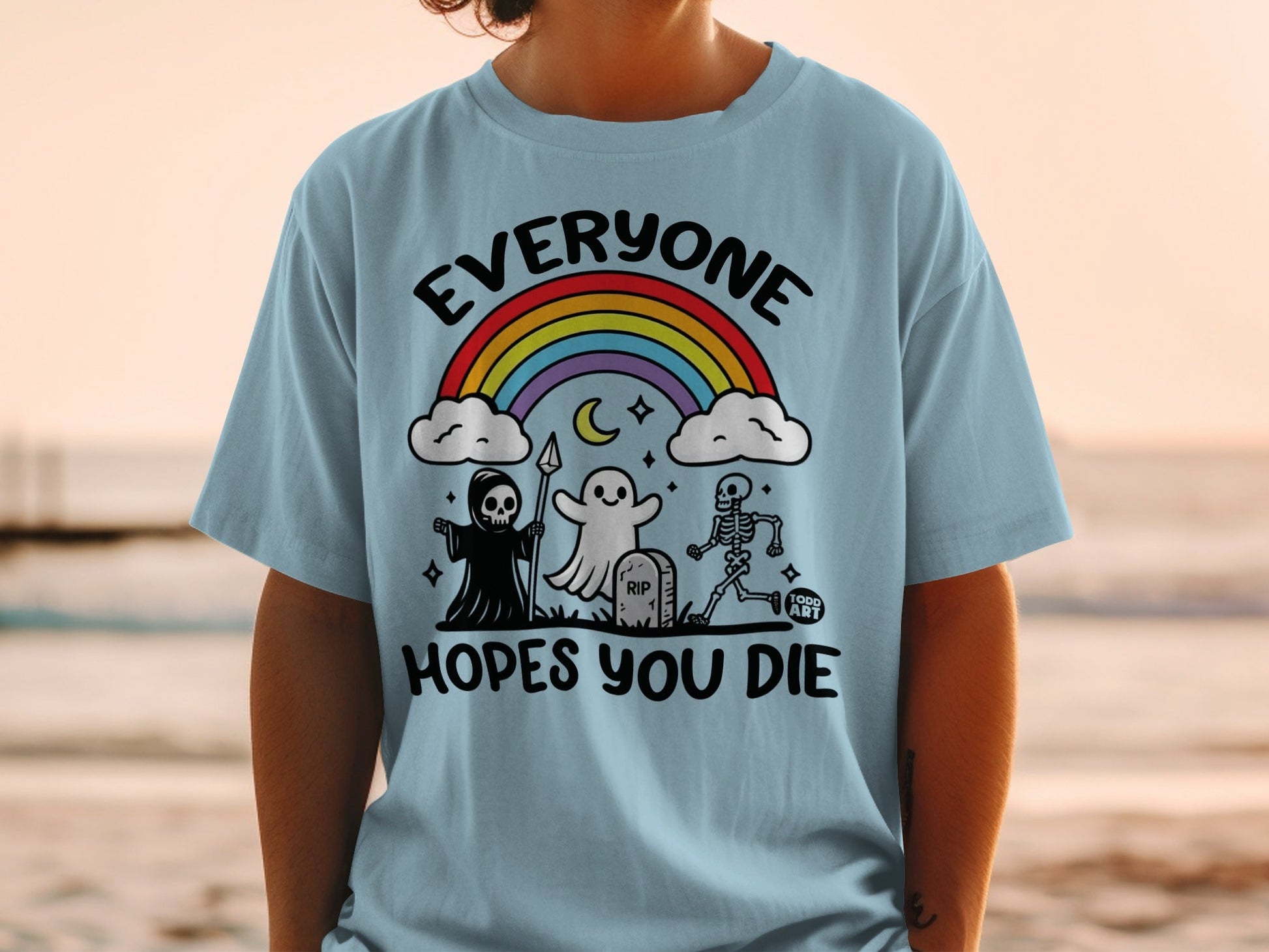 Light blue t-shirt with Halloween characters, rainbow, and text "EVERYONE HOPES YOU DIE".