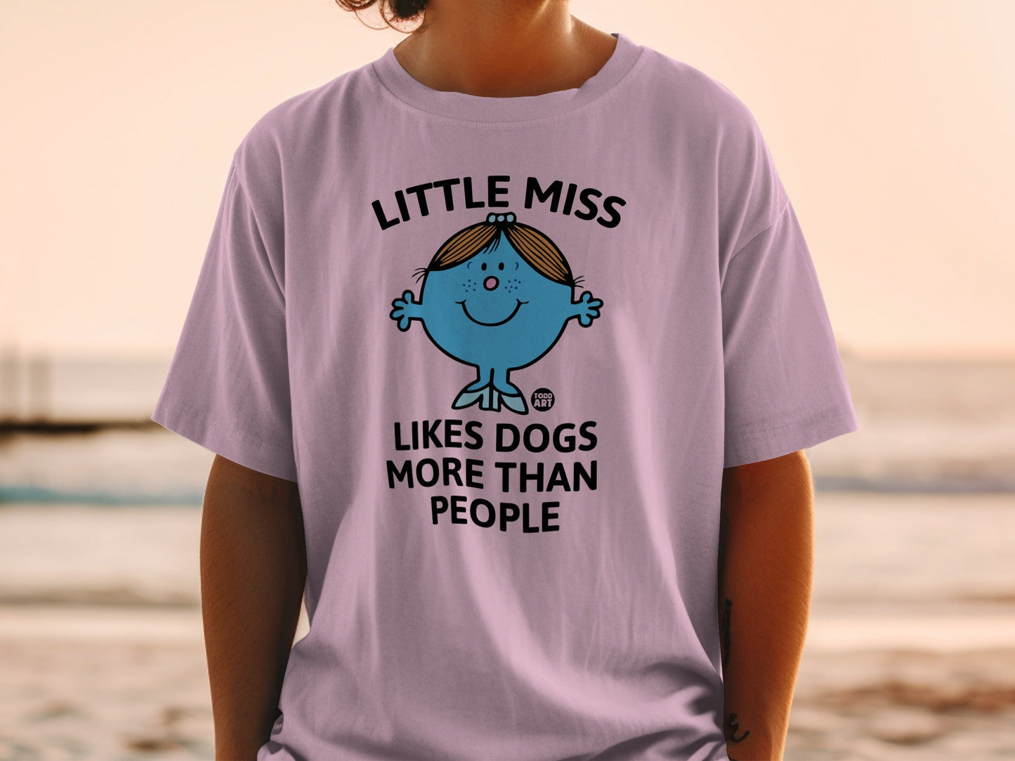 Purple t-shirt with "Little Miss Likes Dogs More Than People" text and cartoon.