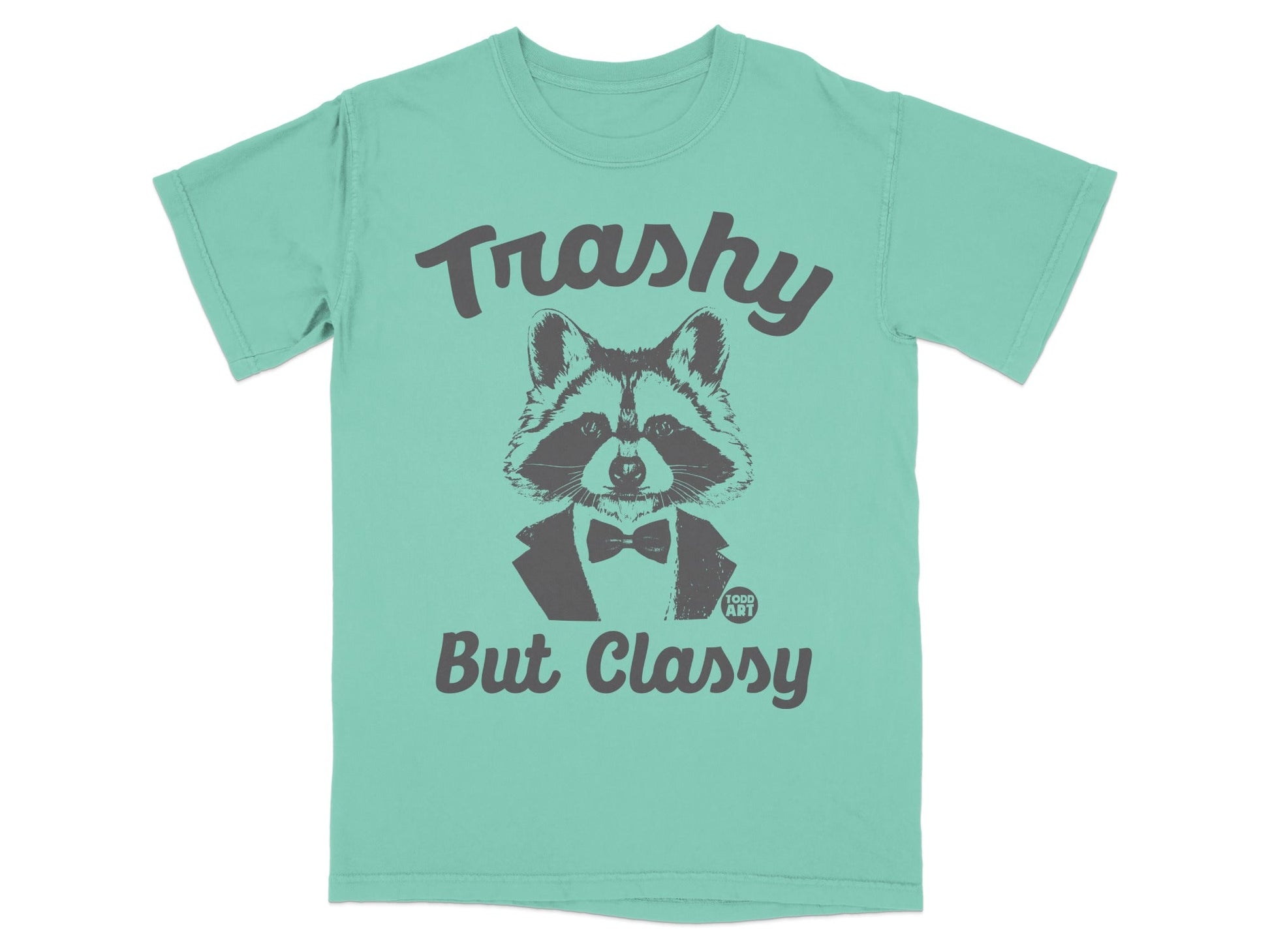 Teal t-shirt with a raccoon wearing a bow tie and the text "Trashy But Classy".