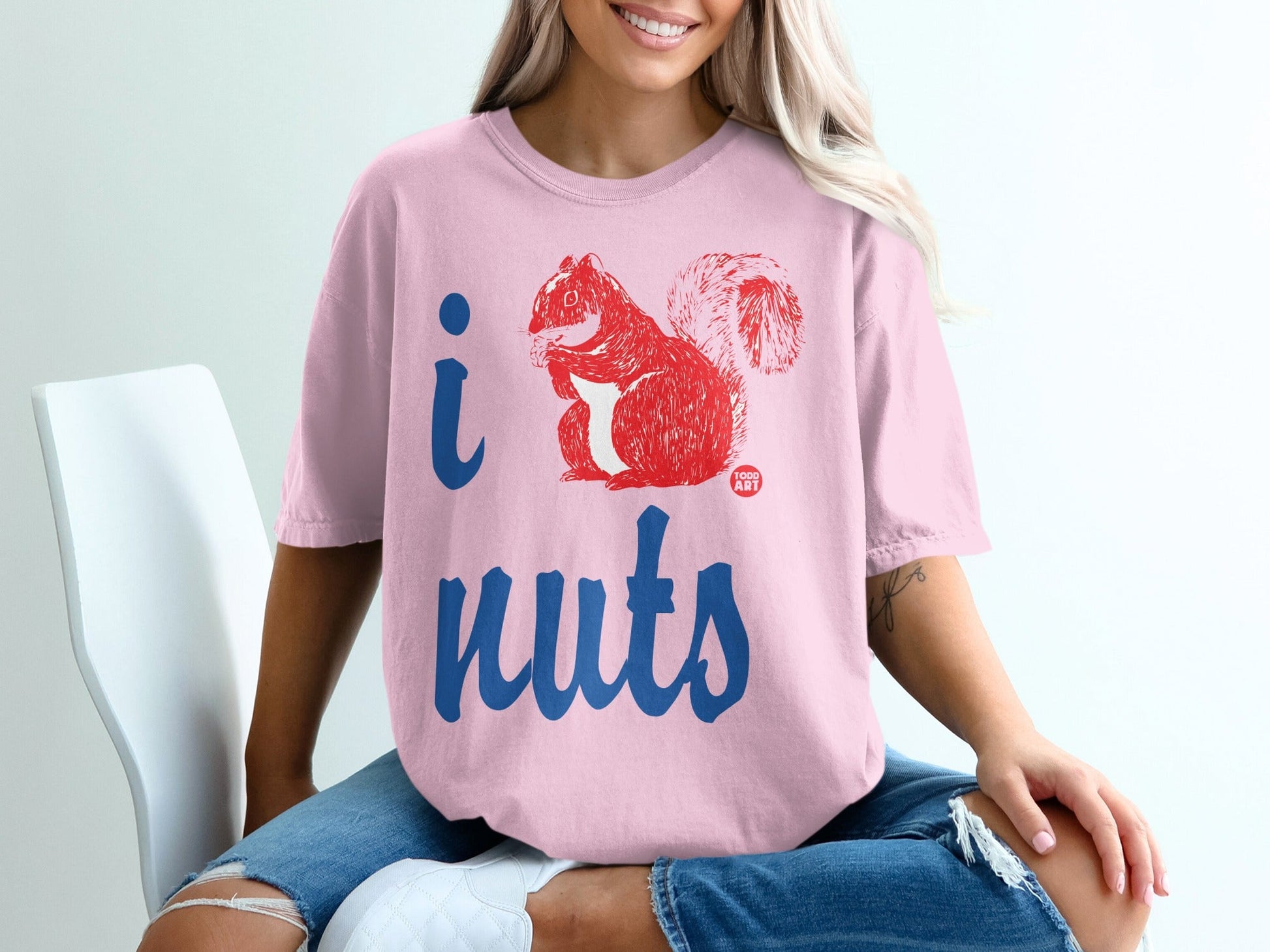 Pink t-shirt with "I nuts" text and red squirrel graphic.