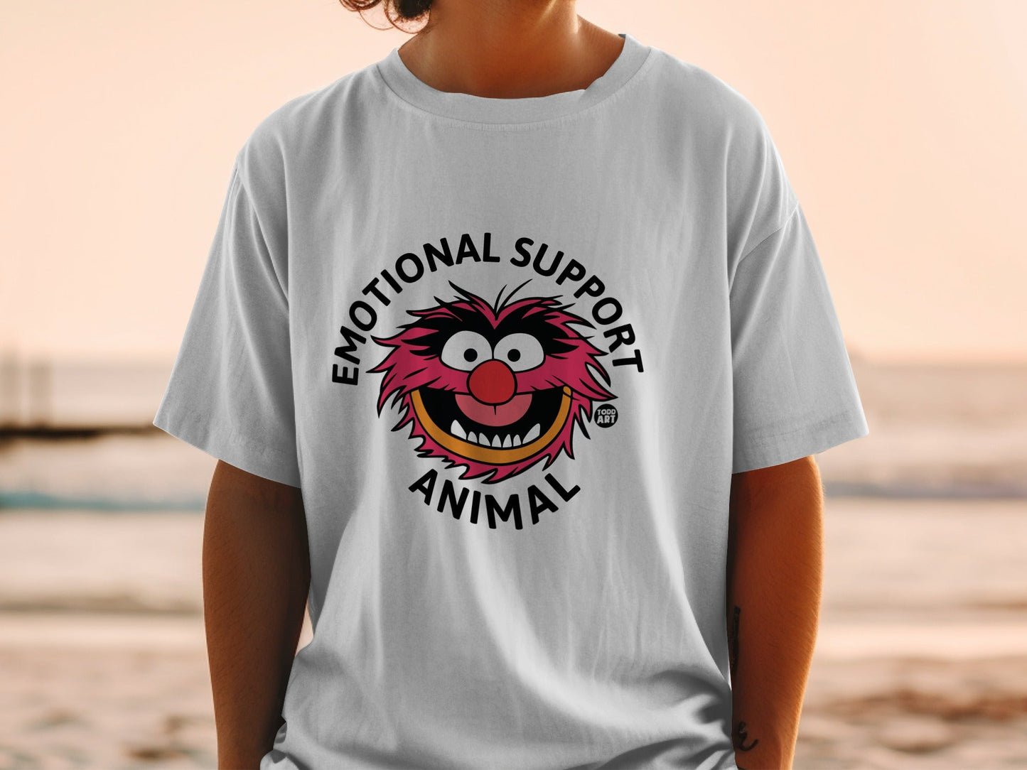 White t-shirt with "Emotional Support Animal" text and cartoon monster graphic.