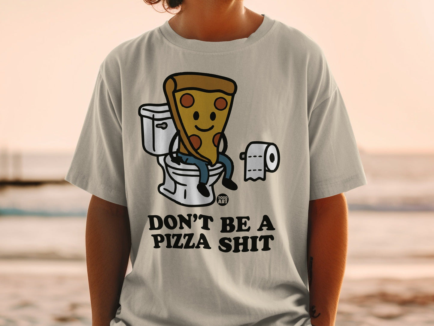 T-shirt with cartoon pizza slice sitting on toilet, text "DON'T BE A PIZZA SHIT".