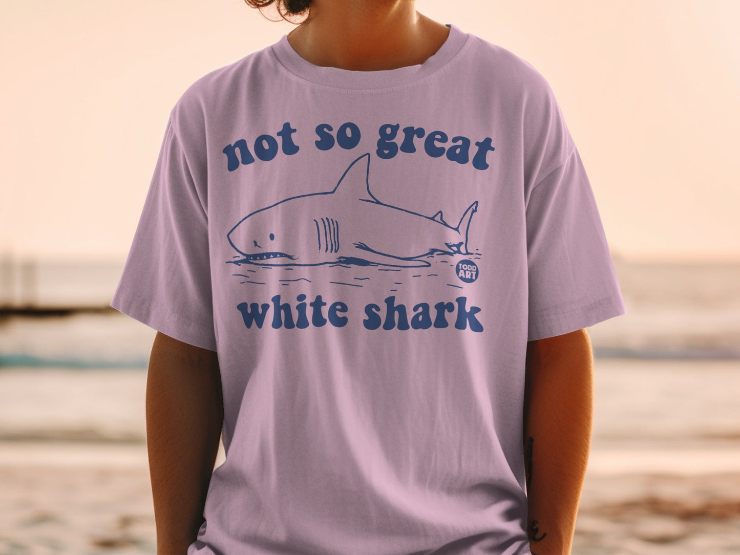 Purple t-shirt with a white shark illustration and "not so great white shark" text.