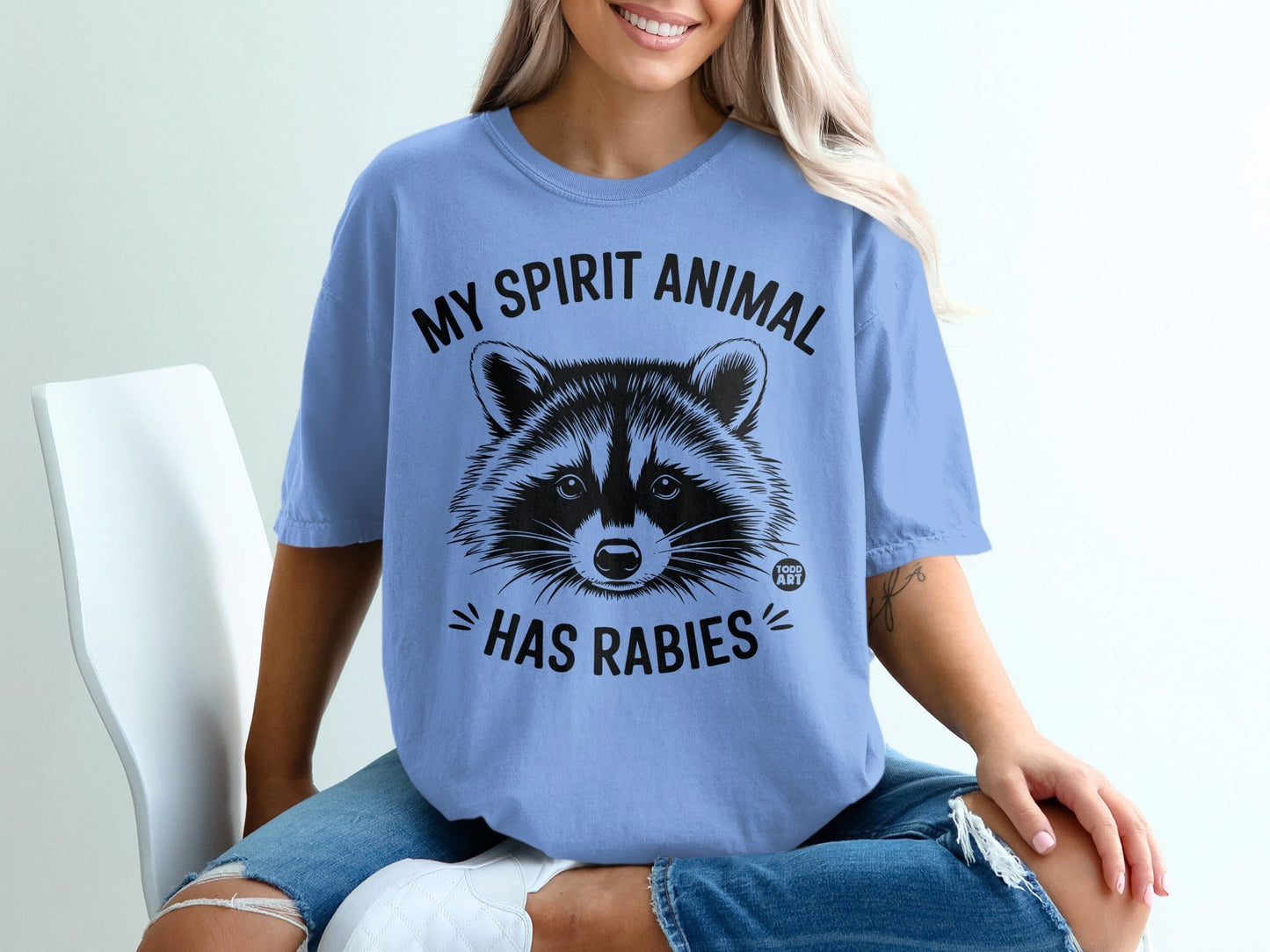 Blue t-shirt with a raccoon graphic and "My spirit animal has rabies" text.