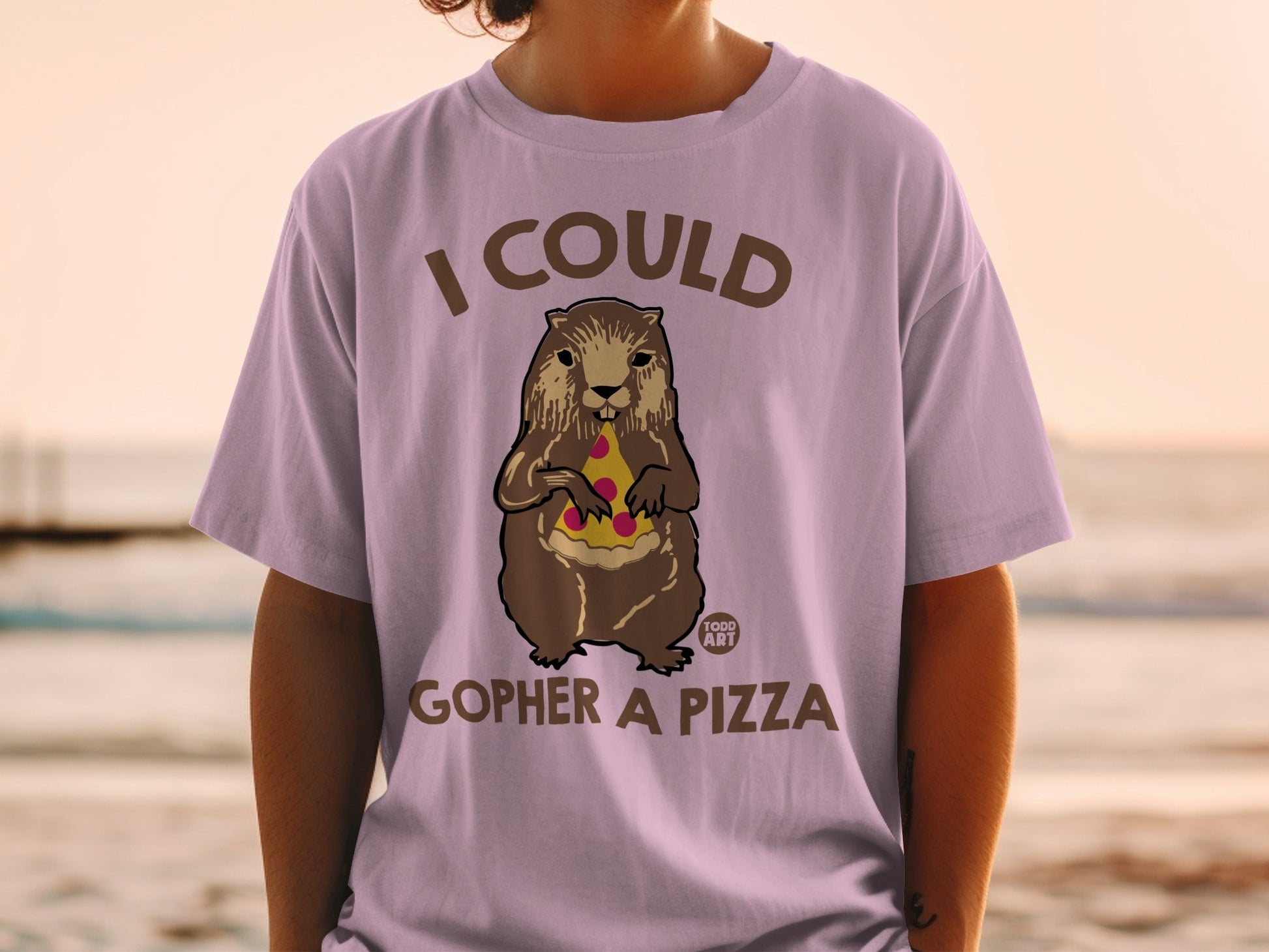 Gopher holding pizza slice on a light purple t-shirt.
