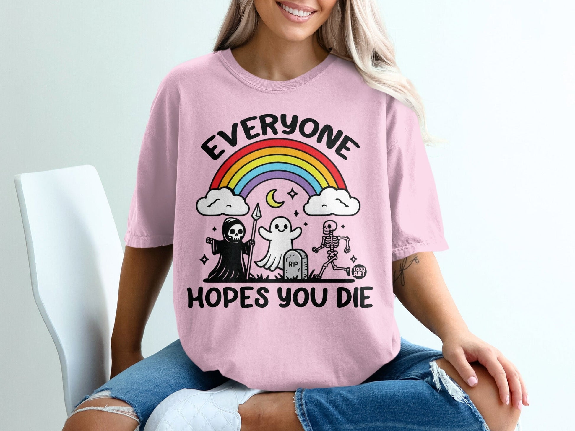 Pink t-shirt with "Everyone Hopes You Die" text and spooky illustrations.