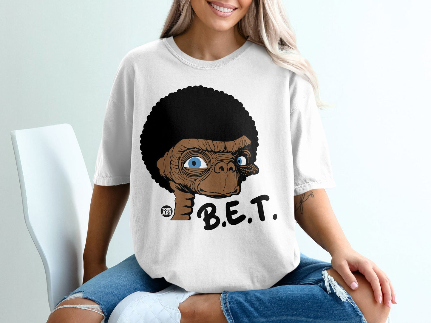 E.T. with afro haircut and "B.E.T." text on a white t-shirt.
