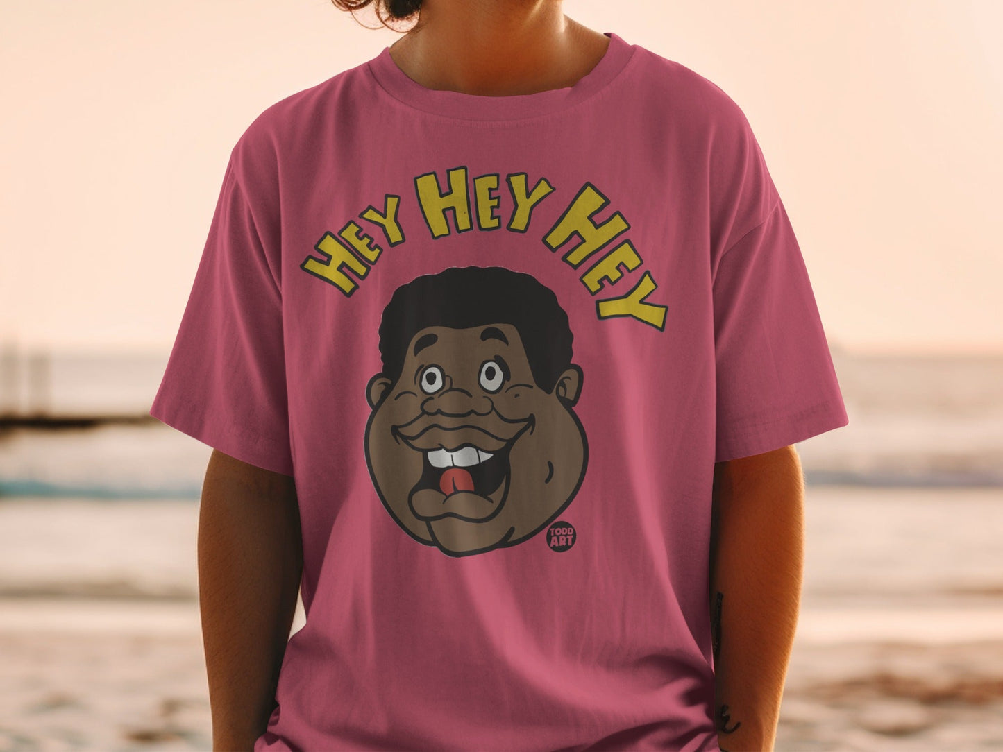 Pink t-shirt with cartoon face and "HEY HEY HEY" text.