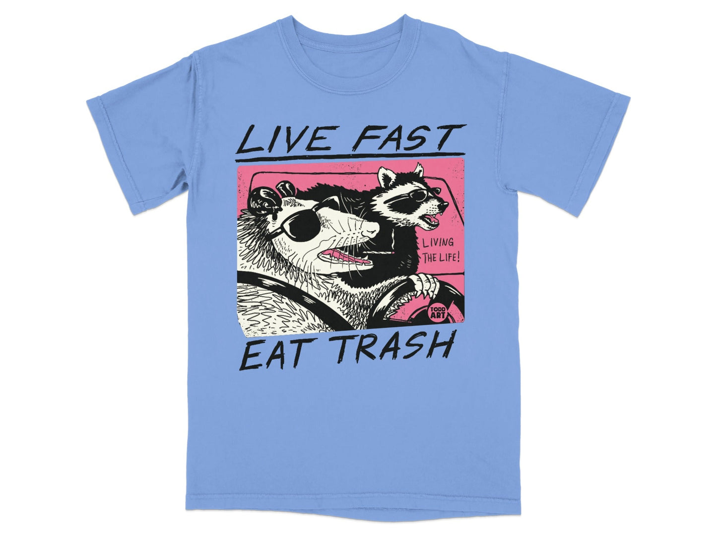 Illustration of a raccoon and possum driving a car with text "LIVE FAST EAT TRASH".