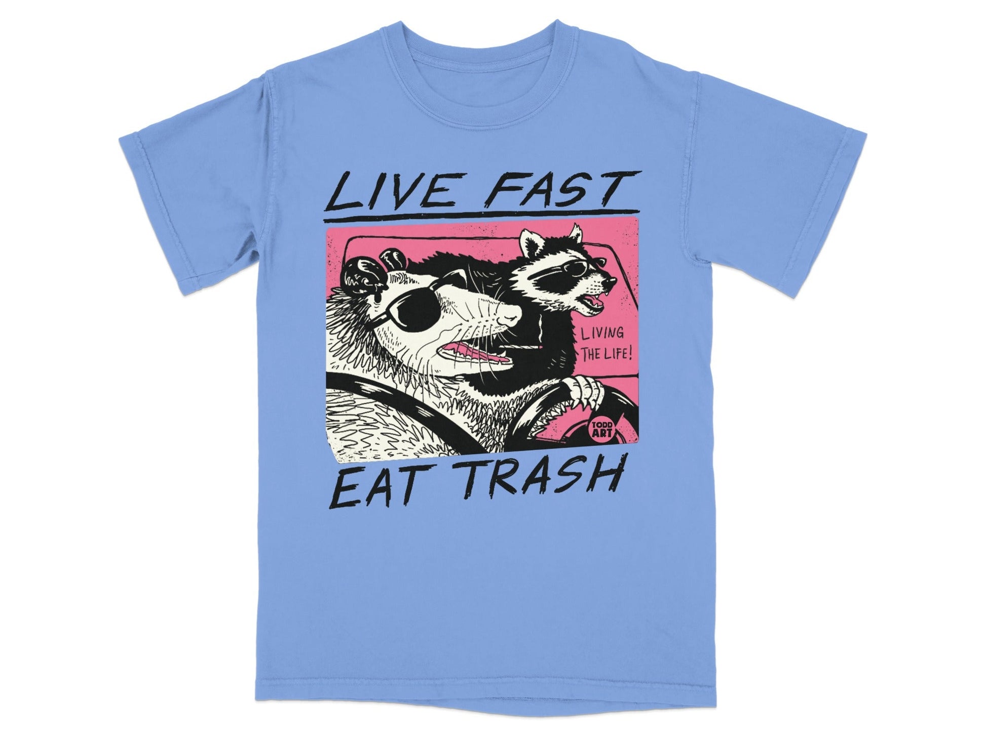 Illustration of a raccoon and possum driving a car with text "LIVE FAST EAT TRASH".