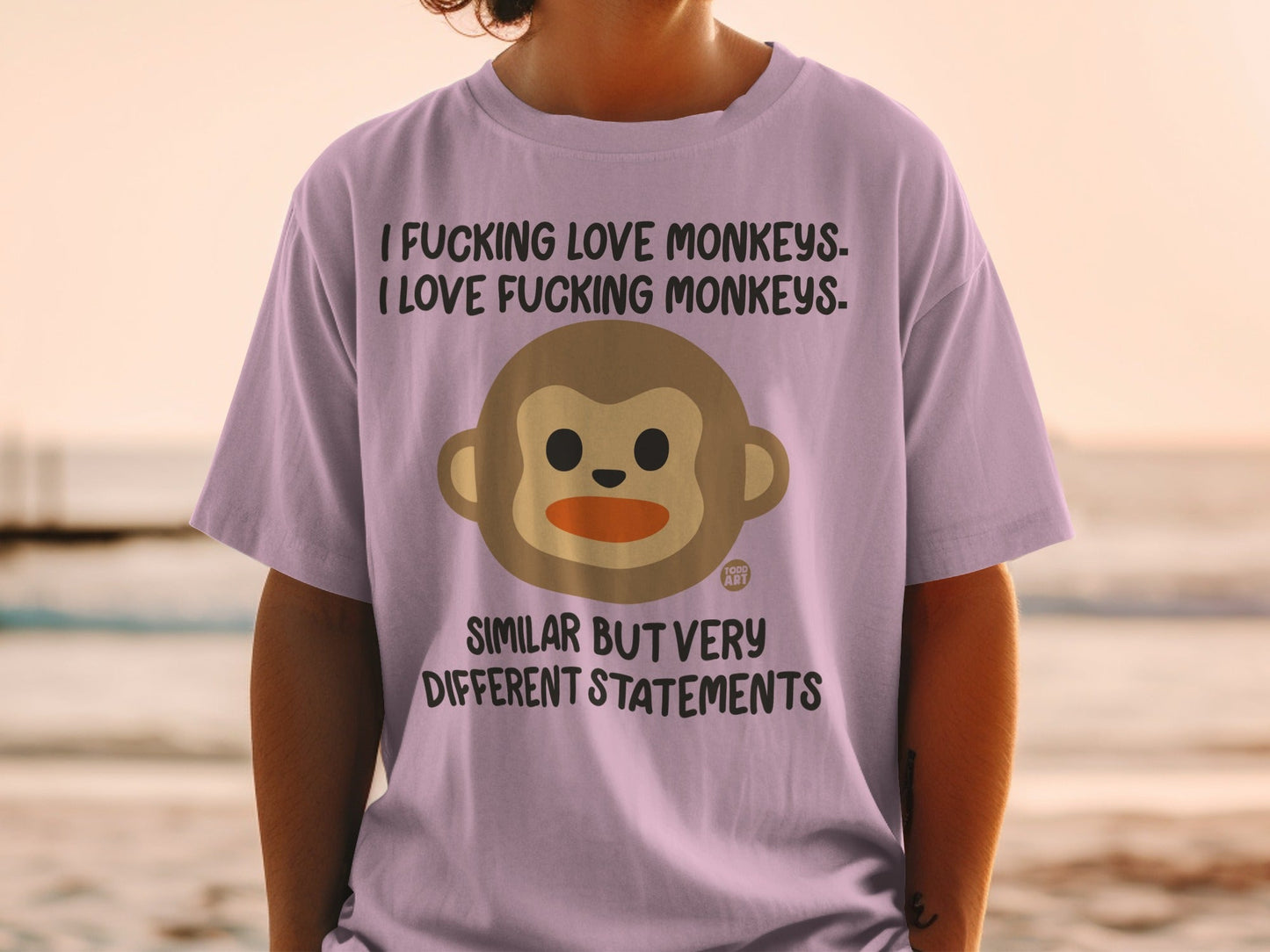 Purple t-shirt with monkey face and contrasting text about monkeys.